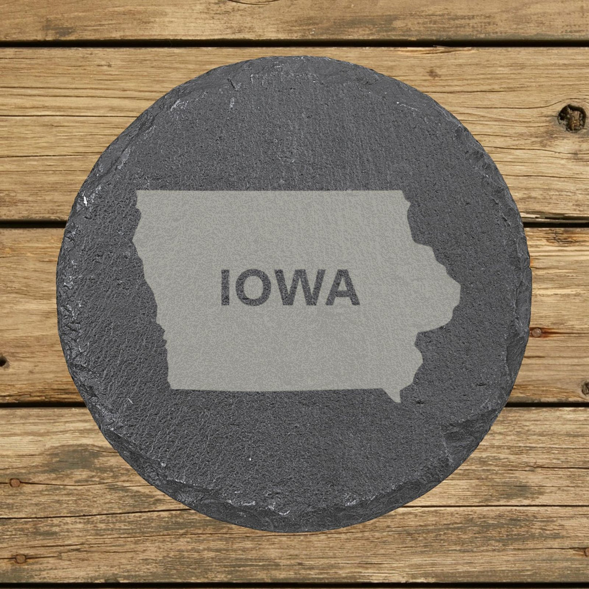 Iowa round slate coaster engraved with the state shape and IOWA in bold lettering