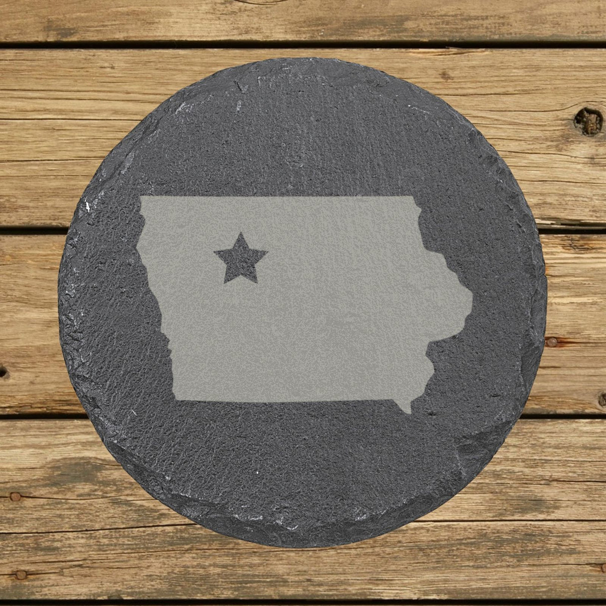 Iowa round slate coaster engraved with the state shape and a star