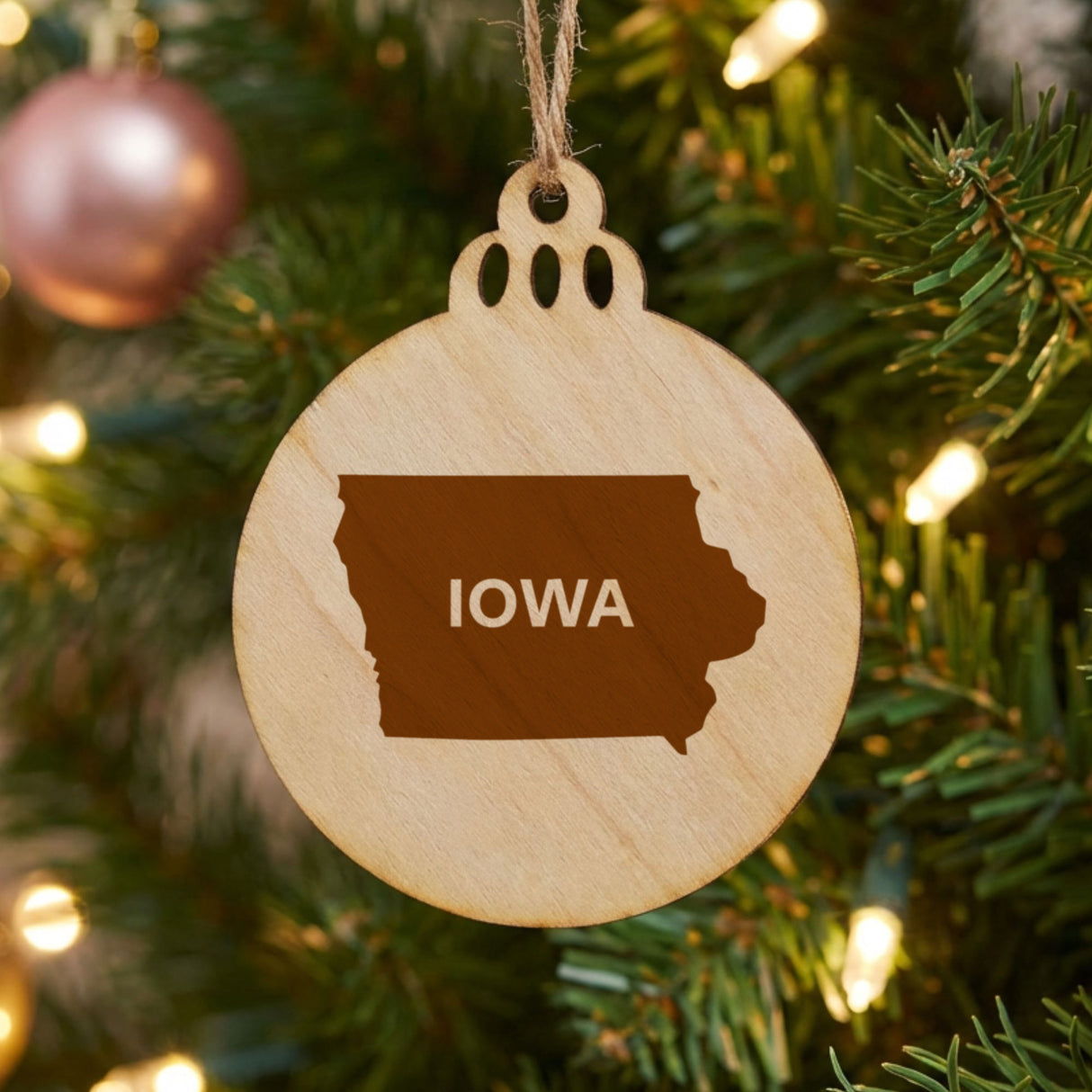 Iowa round wood Christmas ornament engraved with the state shape and IOWA in bold lettering
