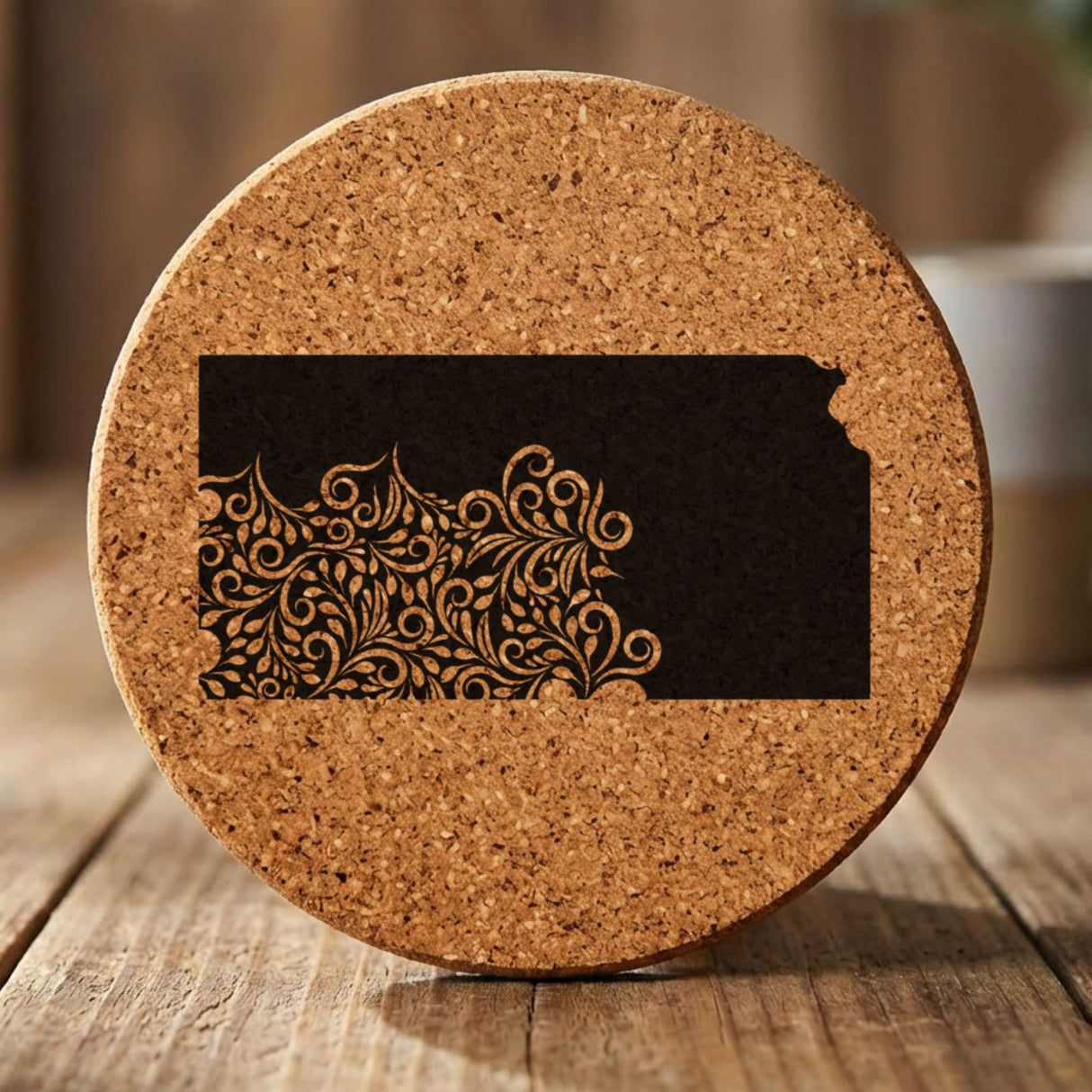 Kansas round cork coaster engraved with the state shape in ornate floral scrollwork