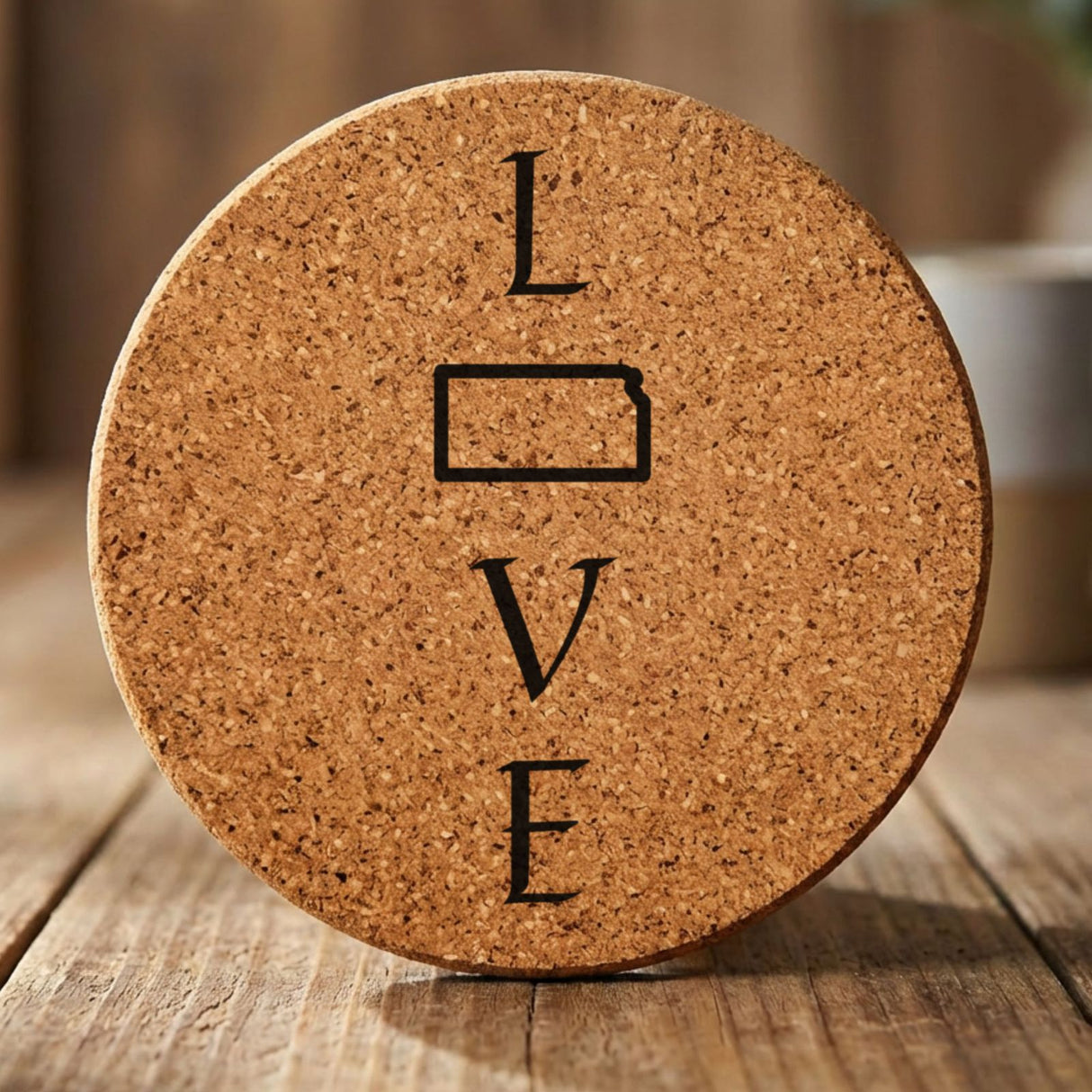 Kansas round cork coaster engraved with LOVE stacked vertically using the state as the letter O