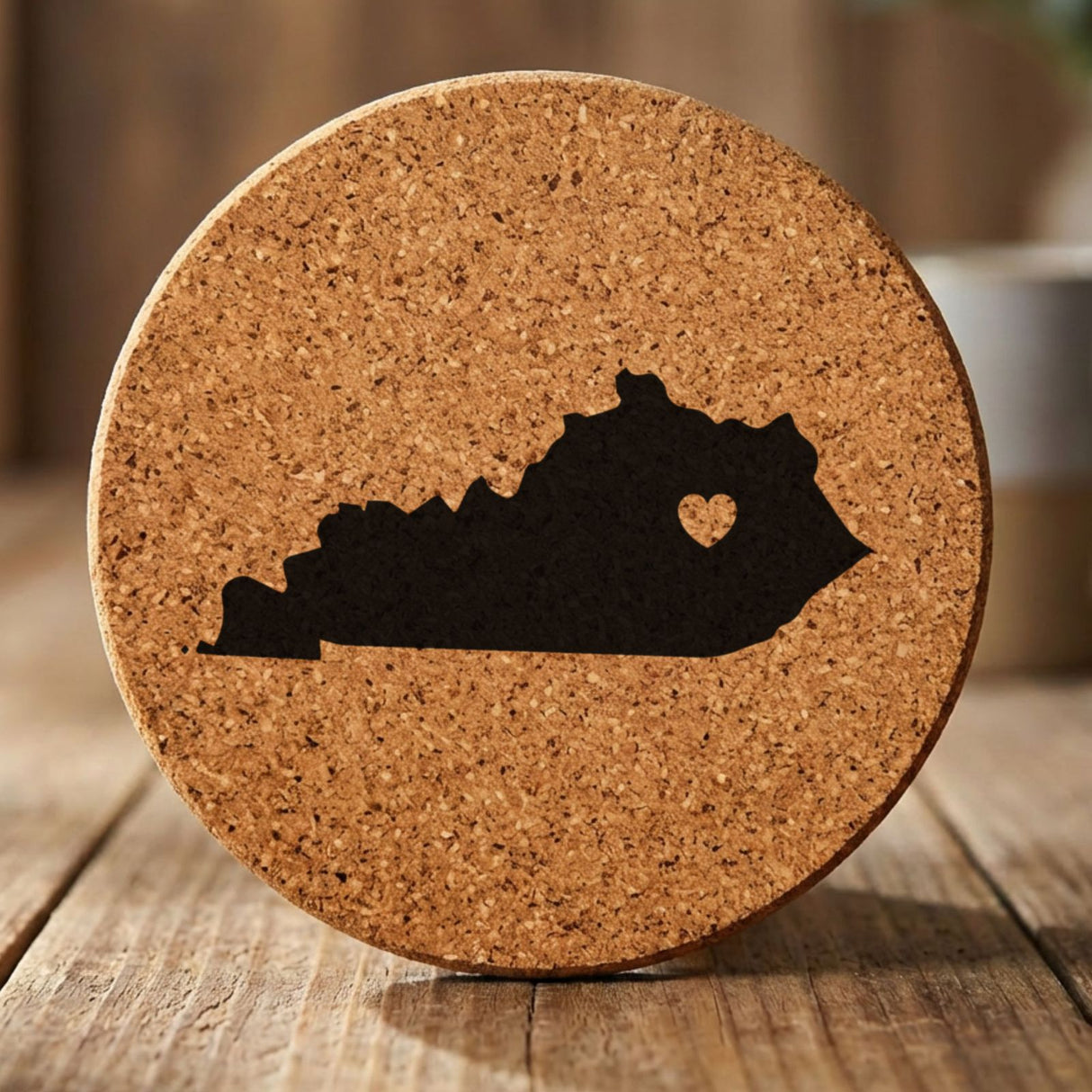 Kentucky round cork coaster engraved with the state shape and a heart