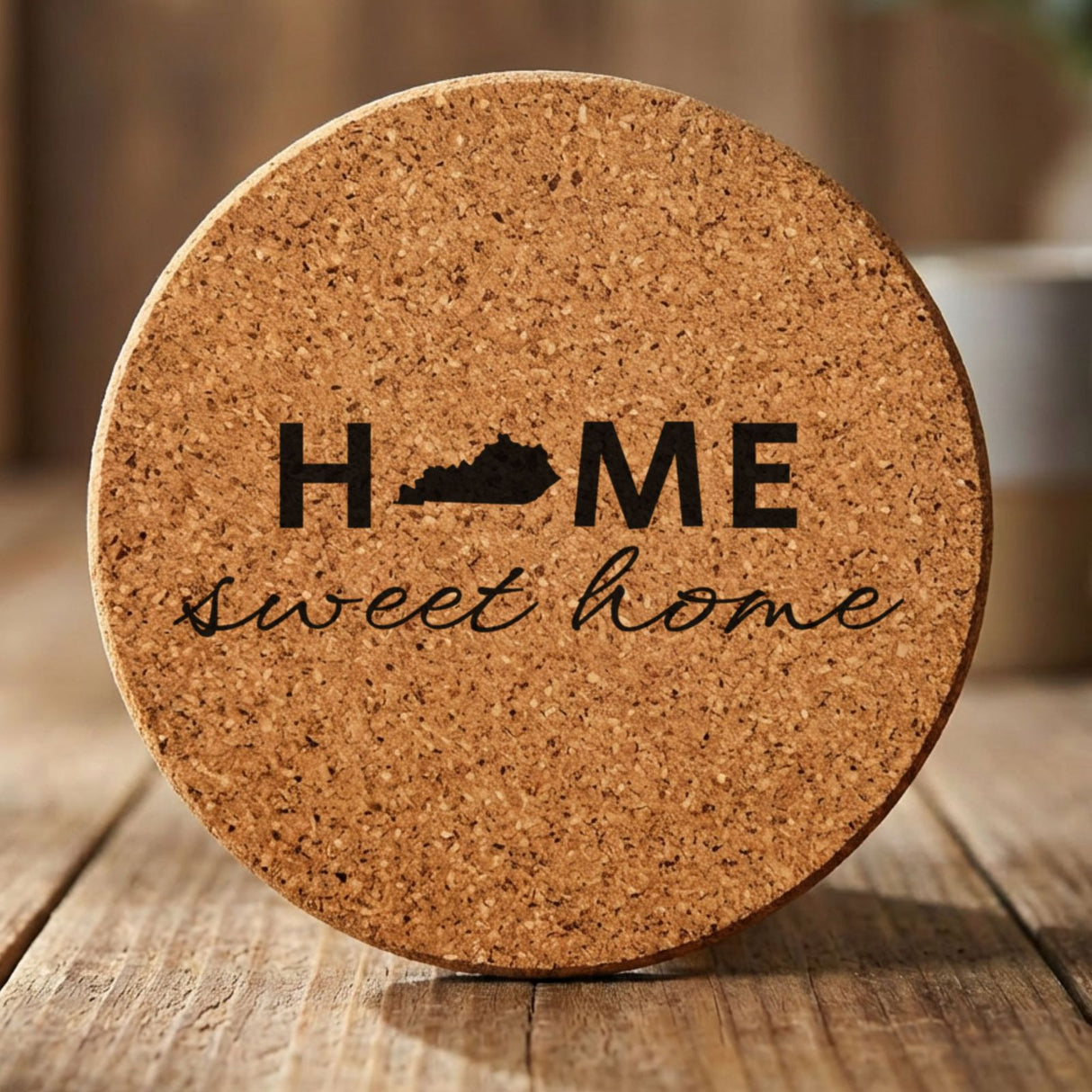 Kentucky round cork coaster engraved with HOME sweet home using the state shape as the letter O