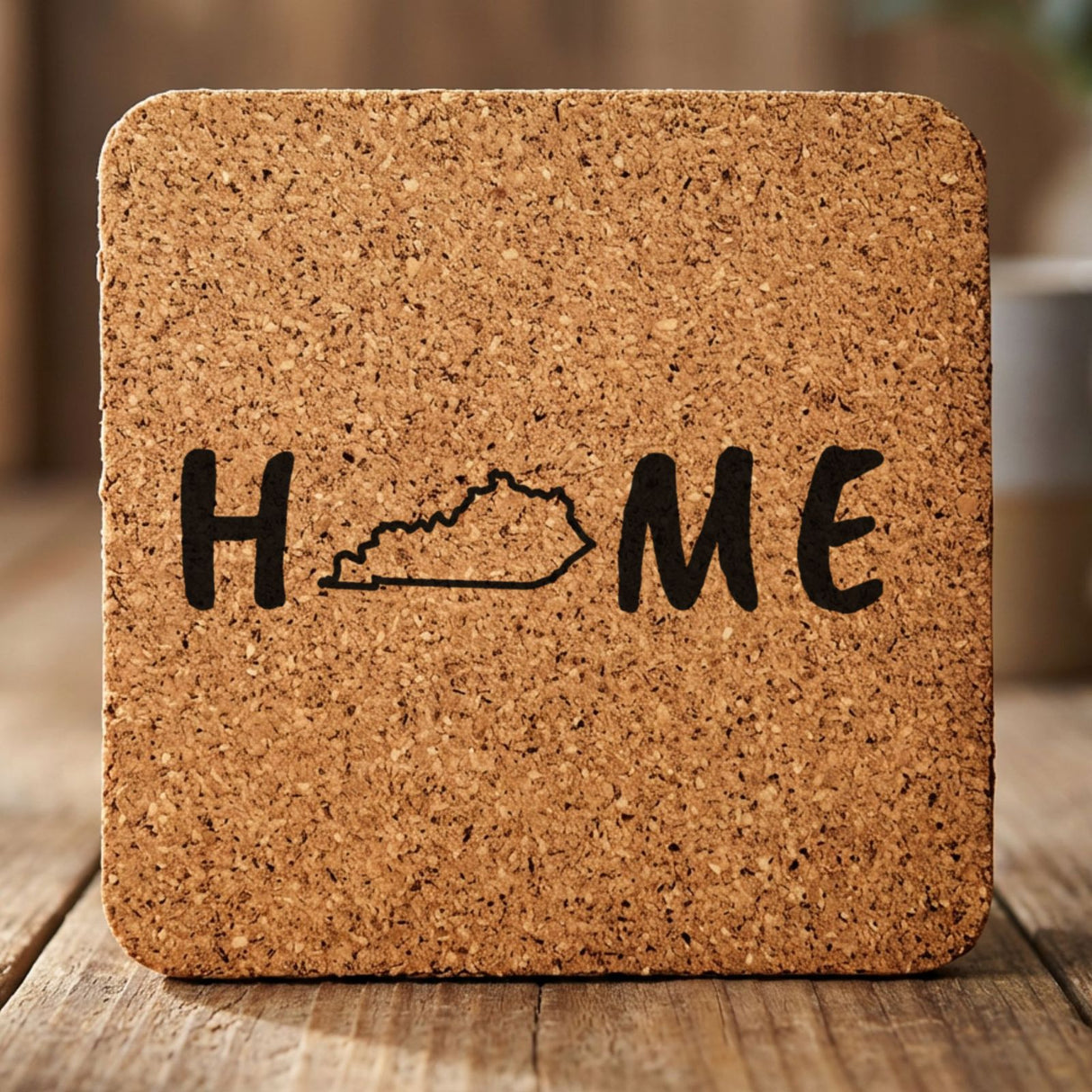 Kentucky square cork coaster engraved with HOME using the state outline as the letter O