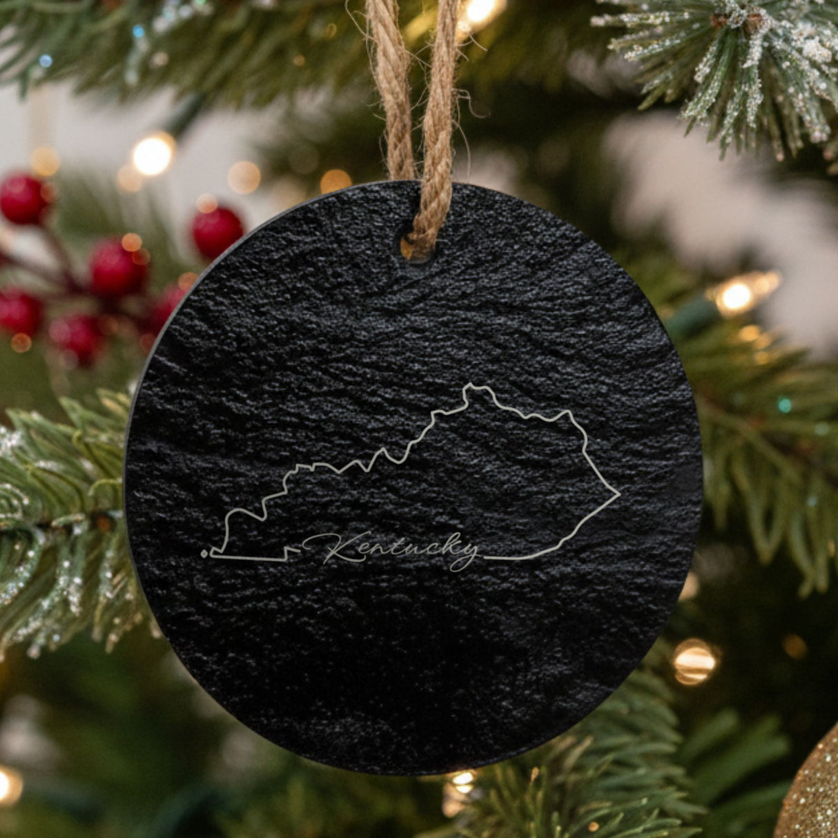 Kentucky round slate Christmas ornament engraved with the state outline and Kentucky in script lettering