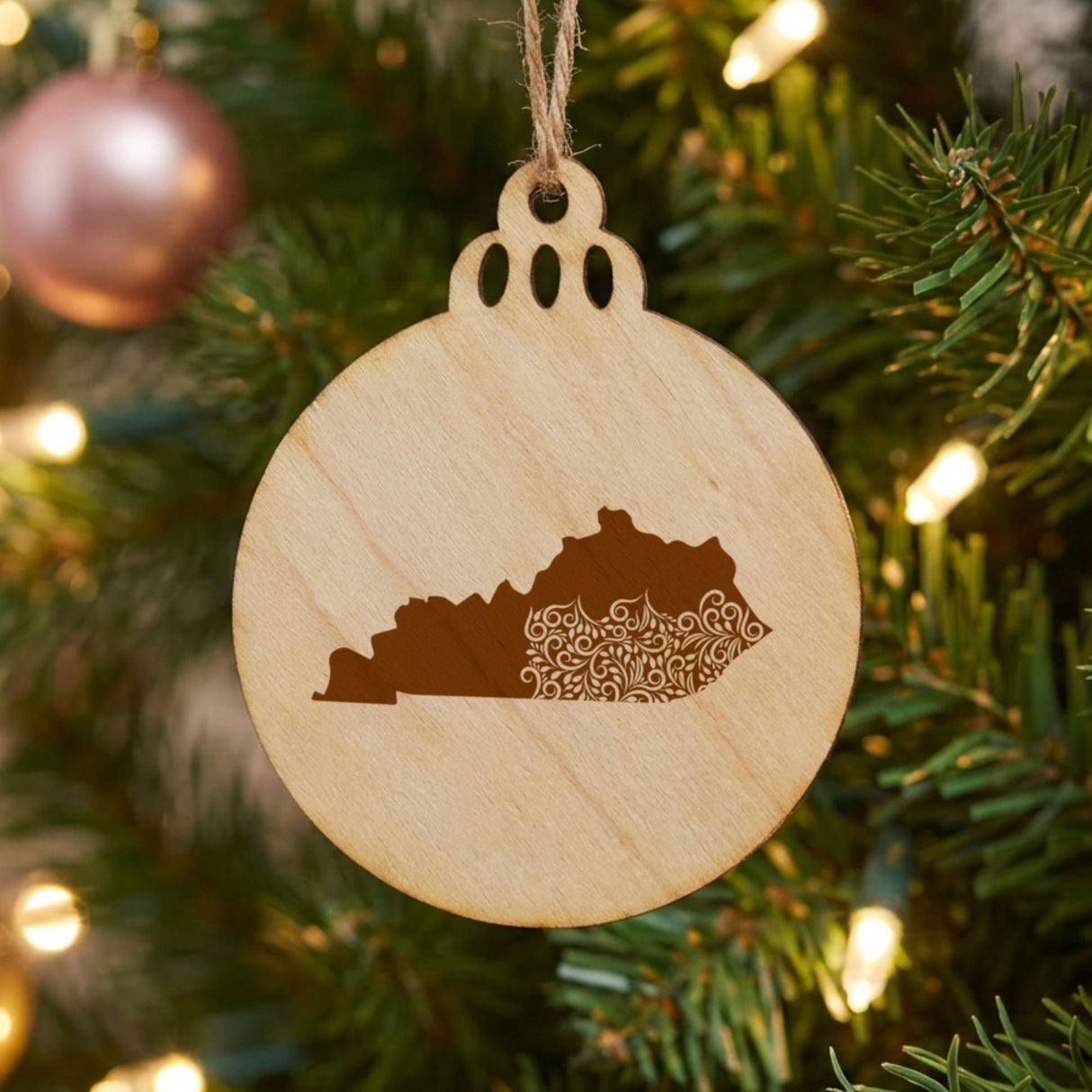 Kentucky round wood Christmas ornament engraved with the state shape in ornate floral scrollwork