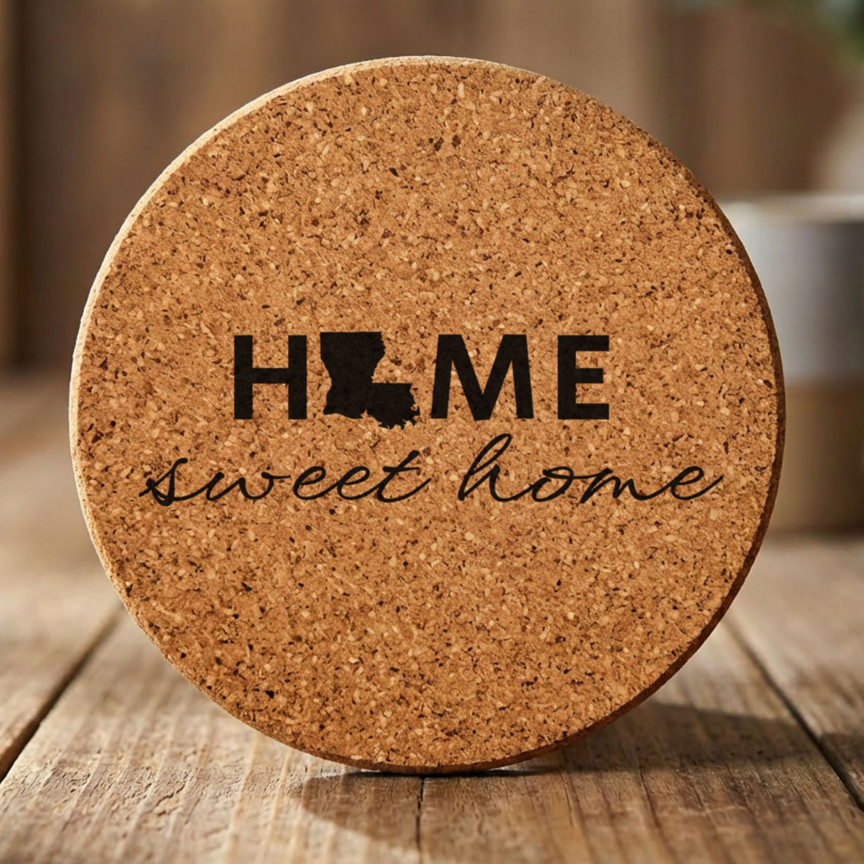Louisiana round cork coaster engraved with HOME sweet home using the state shape as the letter O