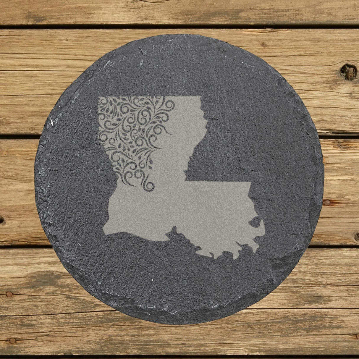 Louisiana round slate coaster engraved with the state shape in ornate floral scrollwork