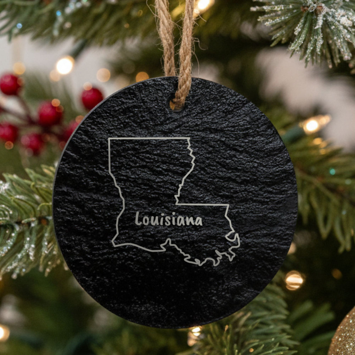 Louisiana round slate Christmas ornament engraved with the state outline and LOUISIANA in hand-drawn brush lettering
