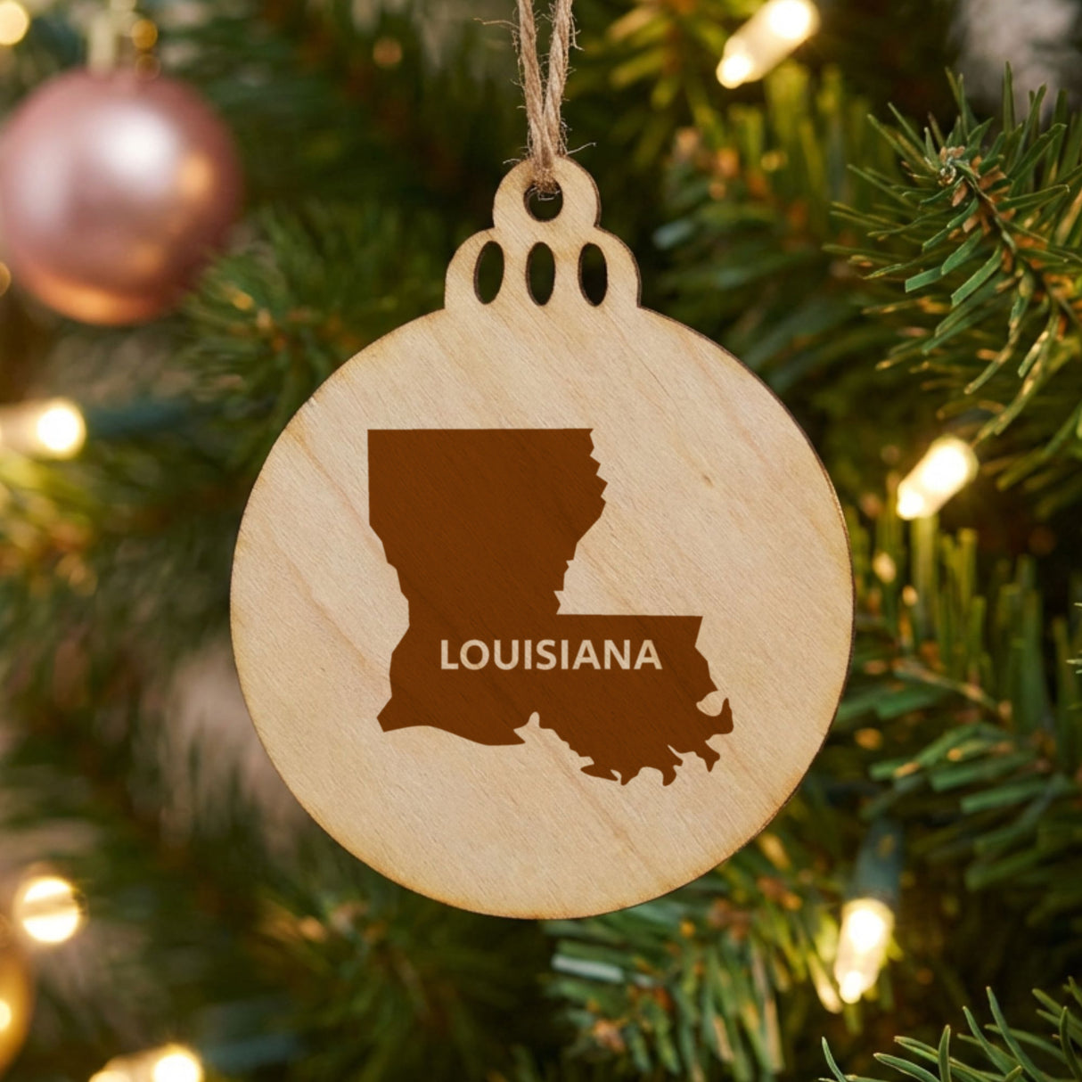 Louisiana round wood Christmas ornament engraved with the state shape and LOUISIANA in bold lettering
