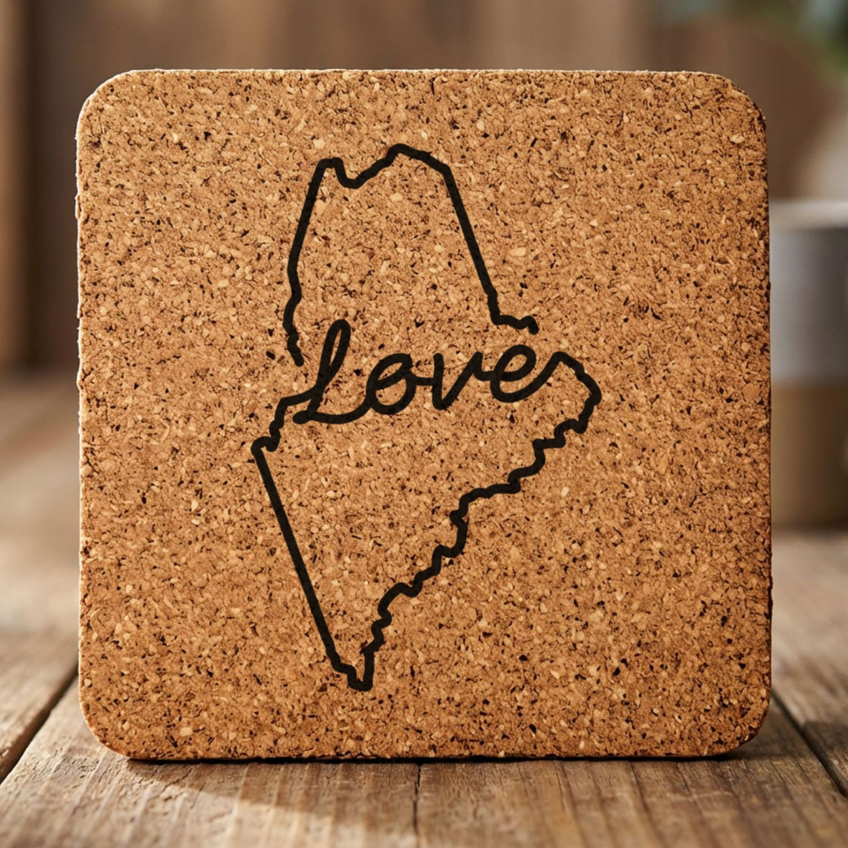 Maine square cork coaster engraved with a hand-drawn state outline and love in cursive