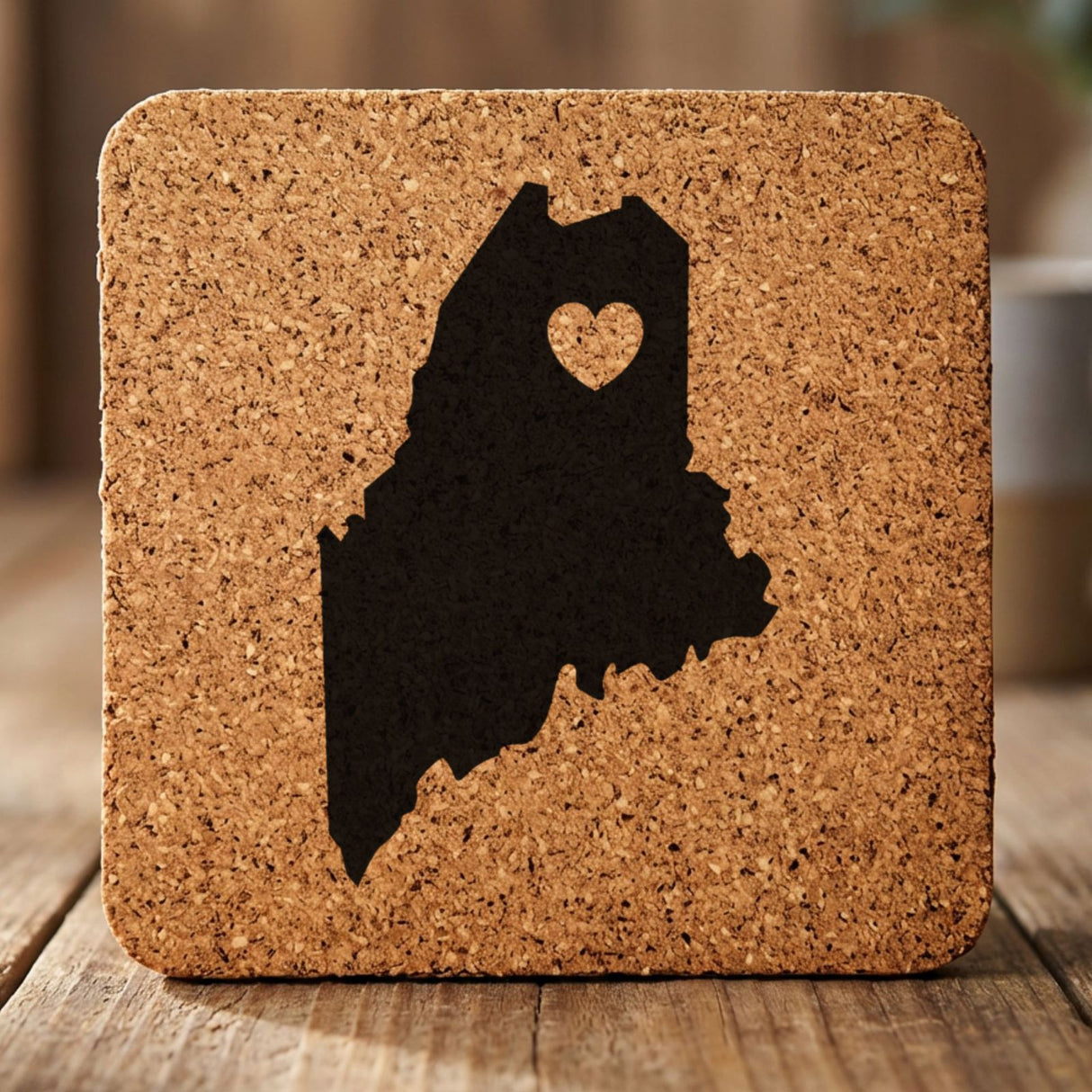 Maine square cork coaster engraved with the state shape and a heart