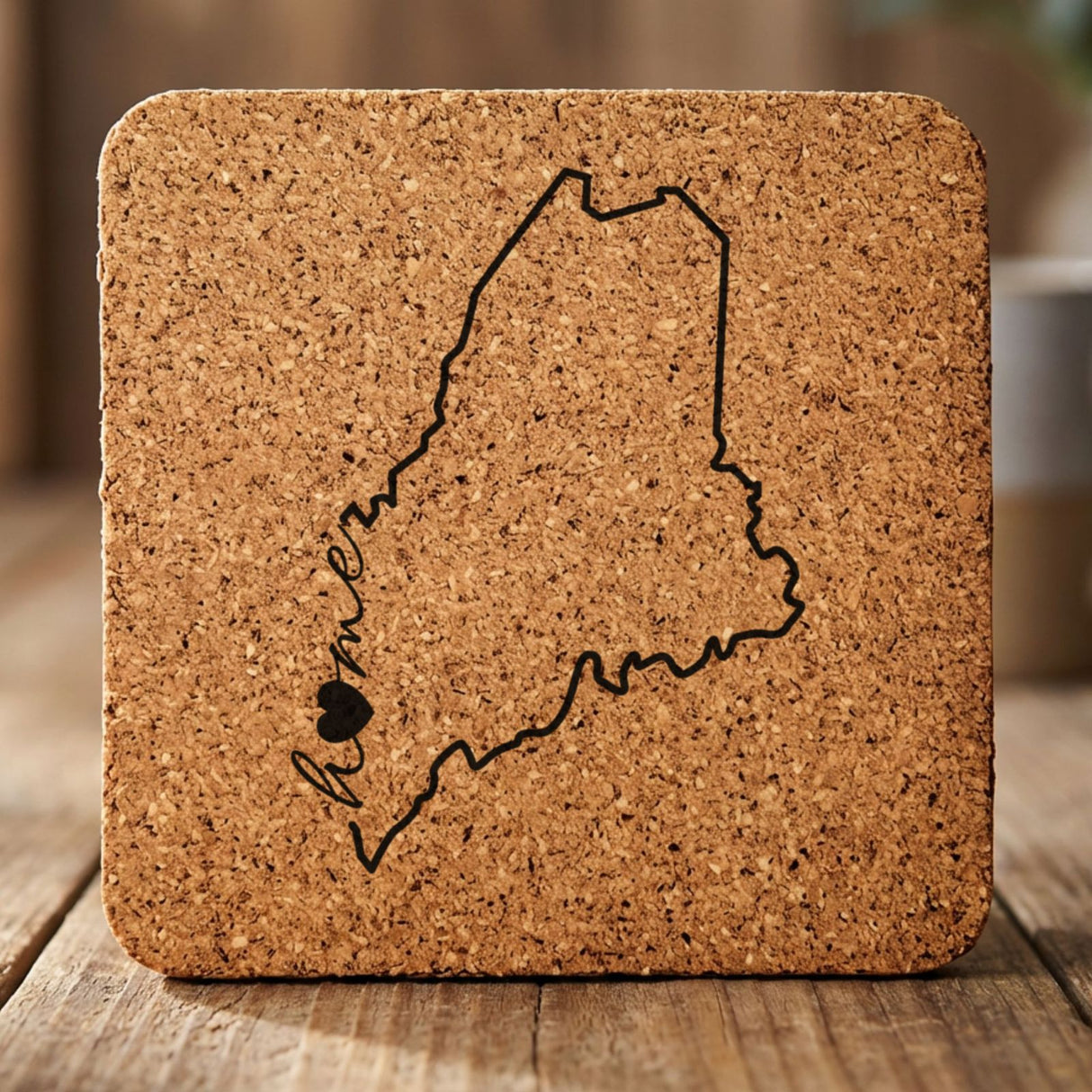 Maine square cork coaster engraved with the state outline and home in script with a heart