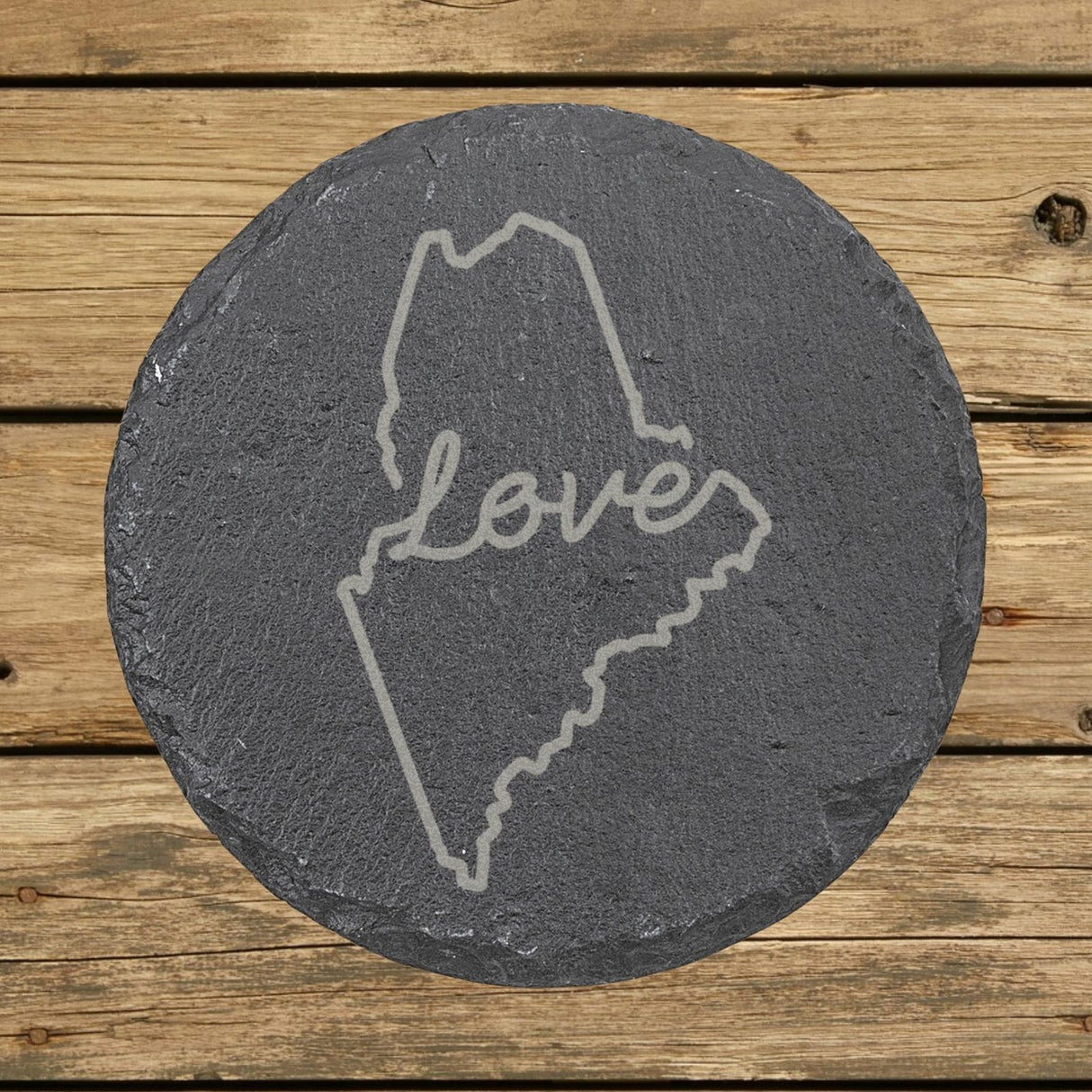 Maine round slate coaster engraved with a hand-drawn state outline and love in cursive
