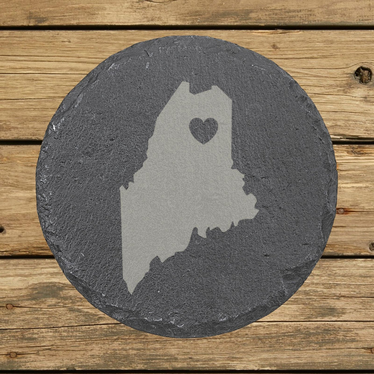 Maine round slate coaster engraved with the state shape and a heart