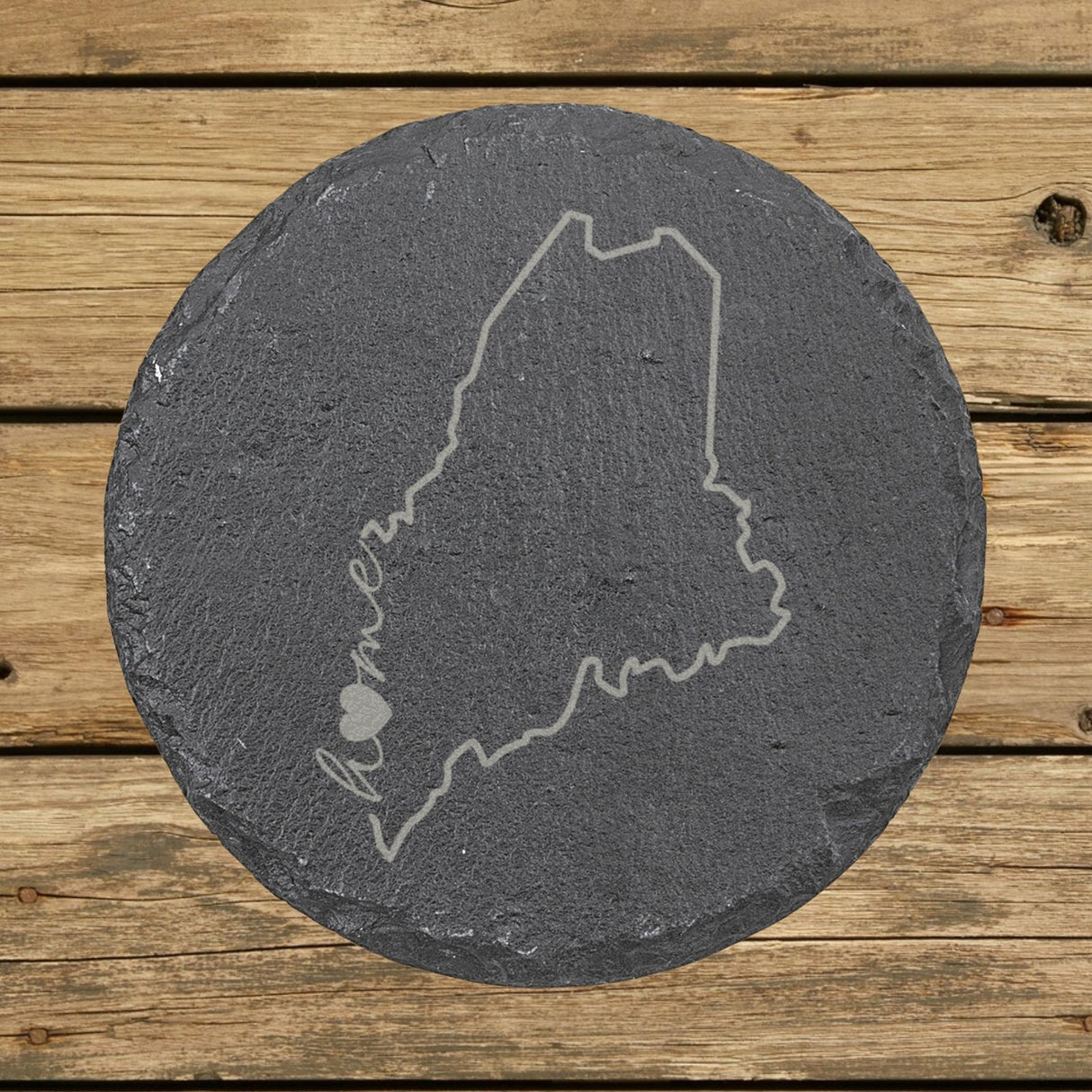 Maine round slate coaster engraved with the state outline and home in script with a heart