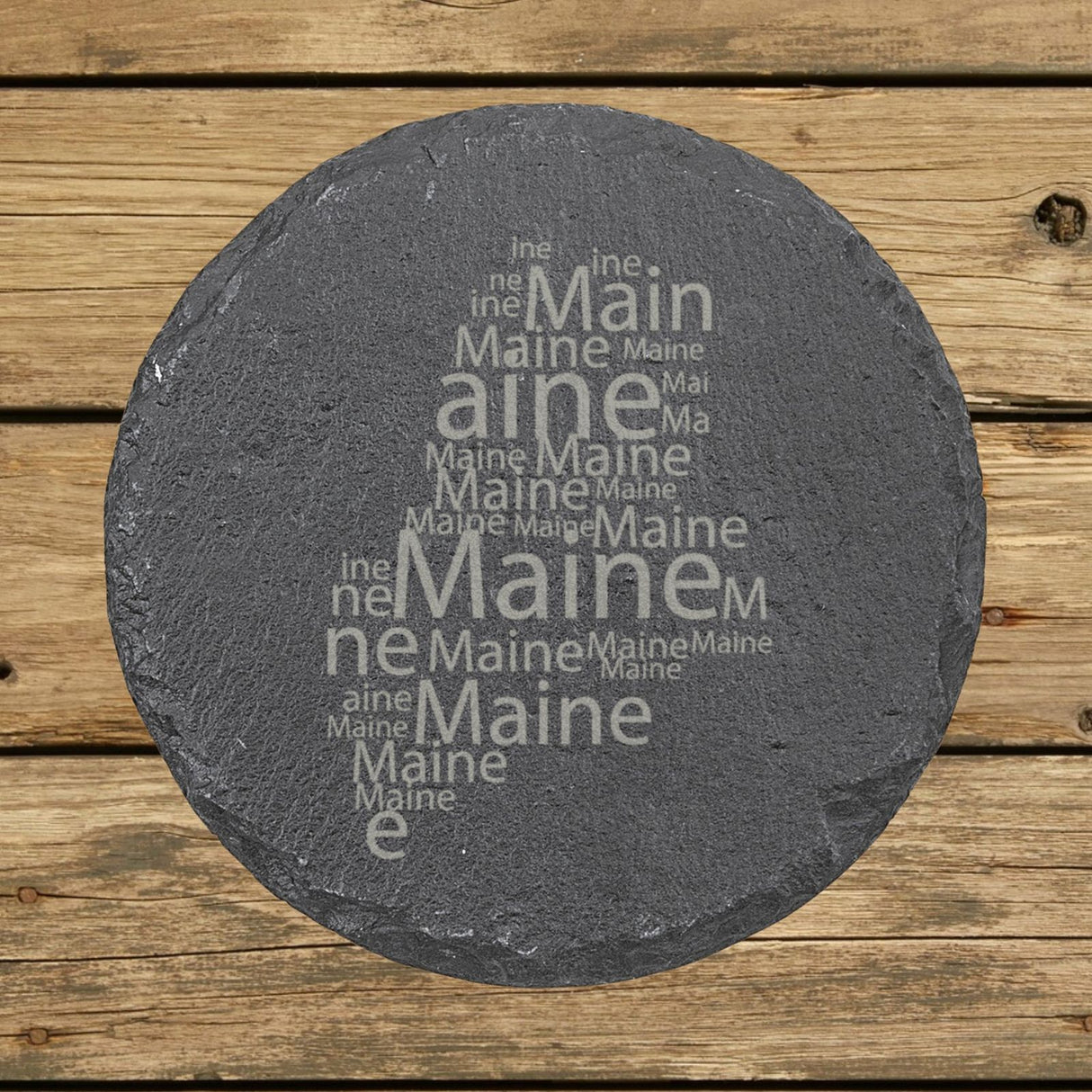 Maine round slate coaster engraved with a word cloud of repeating Maine text