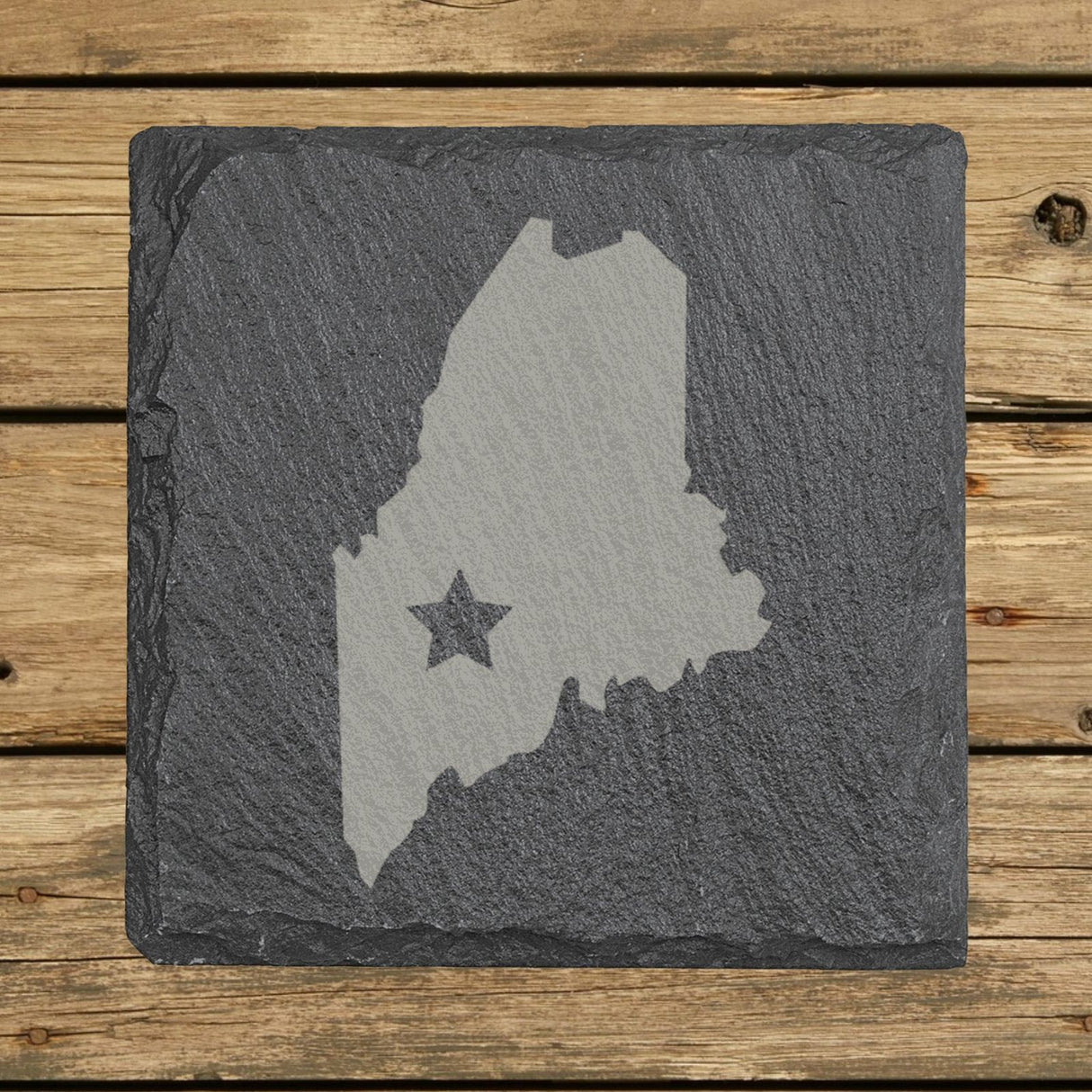 Maine square slate coaster engraved with the state shape and a star