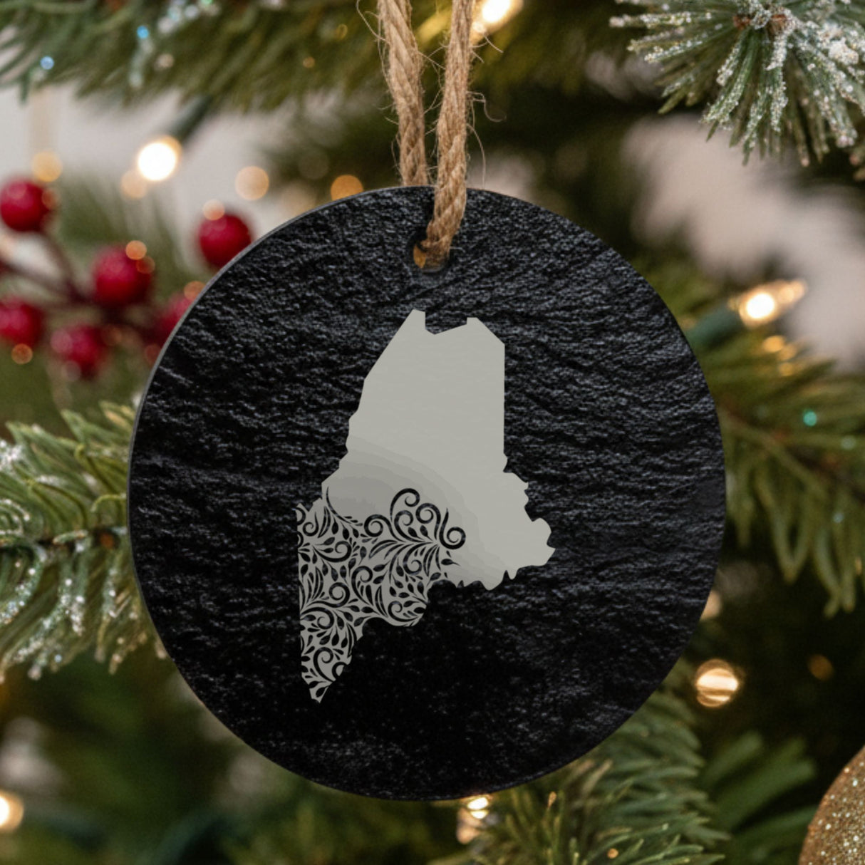 Maine round slate Christmas ornament engraved with the state shape in ornate floral scrollwork