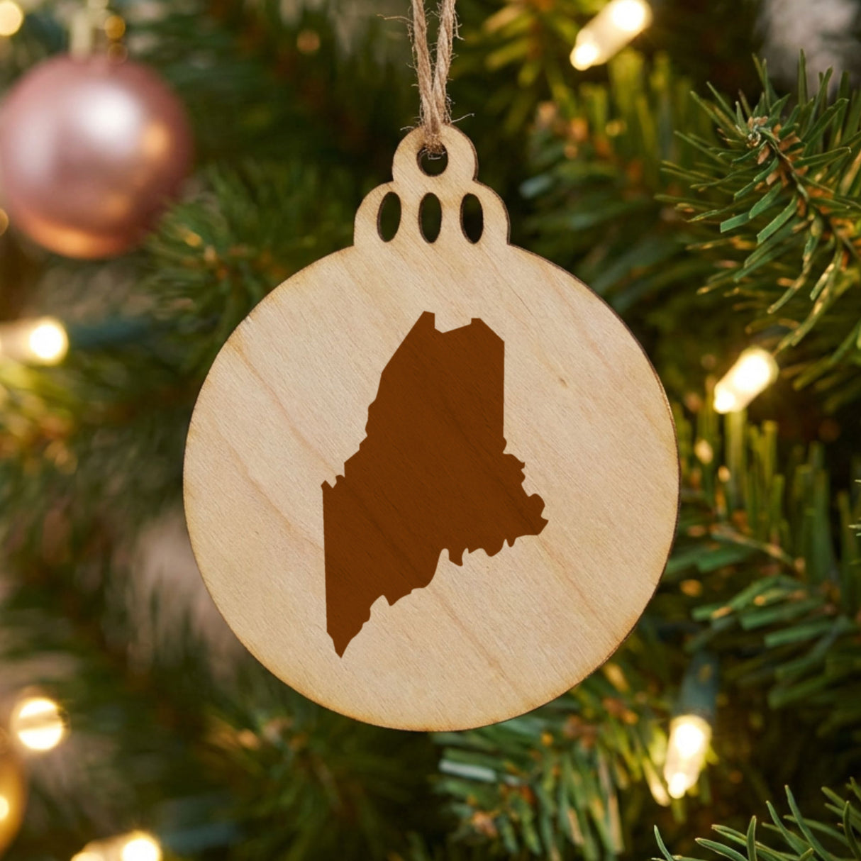 Maine round wood Christmas ornament with the full state shape engraved