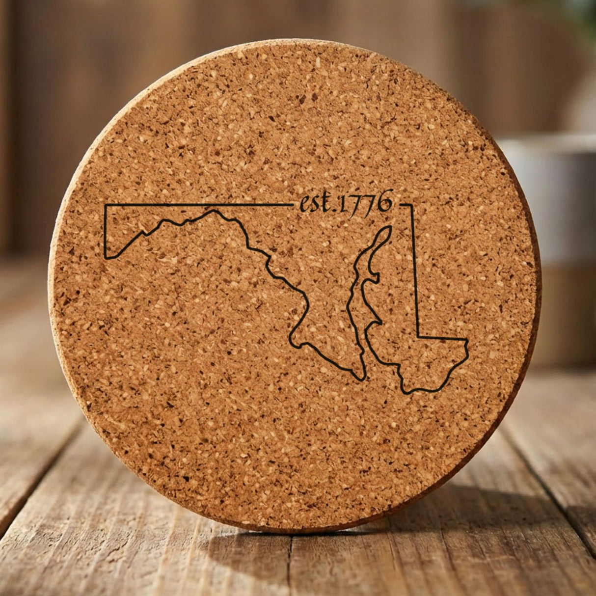 Maryland round cork coaster engraved with the state outline and est. 1776