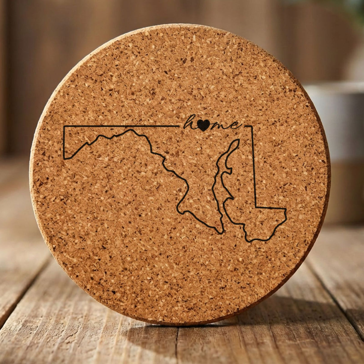Maryland round cork coaster engraved with the state outline and home in script with a heart