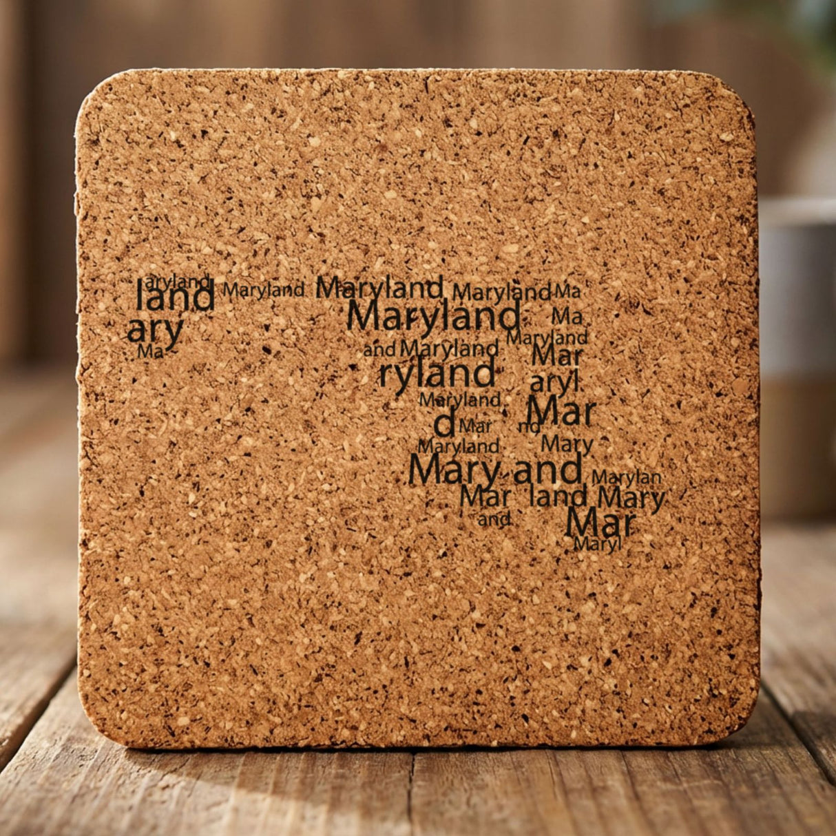 Maryland square cork coaster engraved with a word cloud of repeating Maryland text