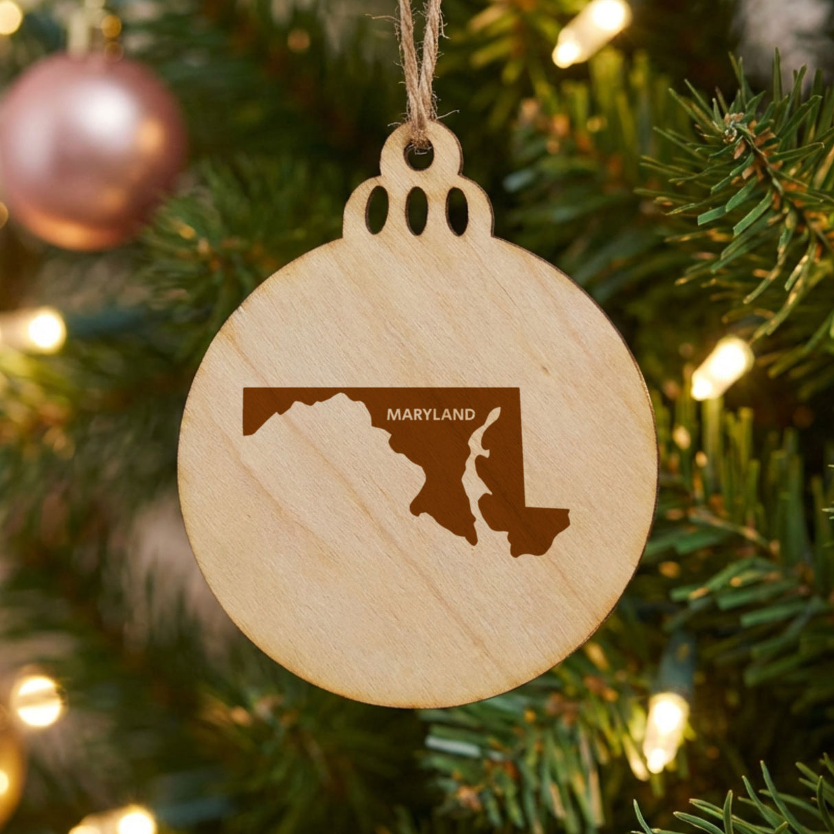 Maryland round wood Christmas ornament engraved with the state shape and MARYLAND in bold lettering