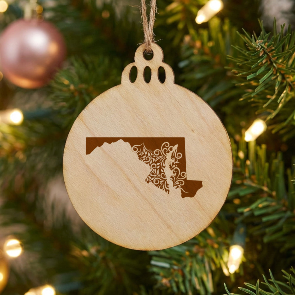 Maryland round wood Christmas ornament engraved with the state shape in ornate floral scrollwork