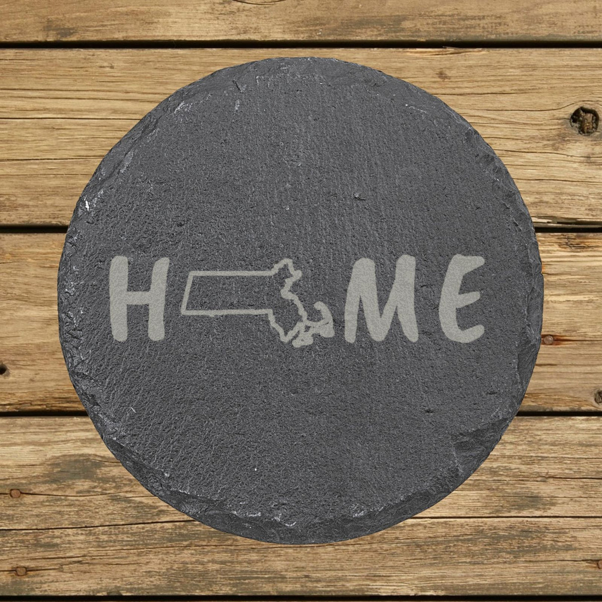 Massachusetts round slate coaster engraved with HOME using the state outline as the letter O