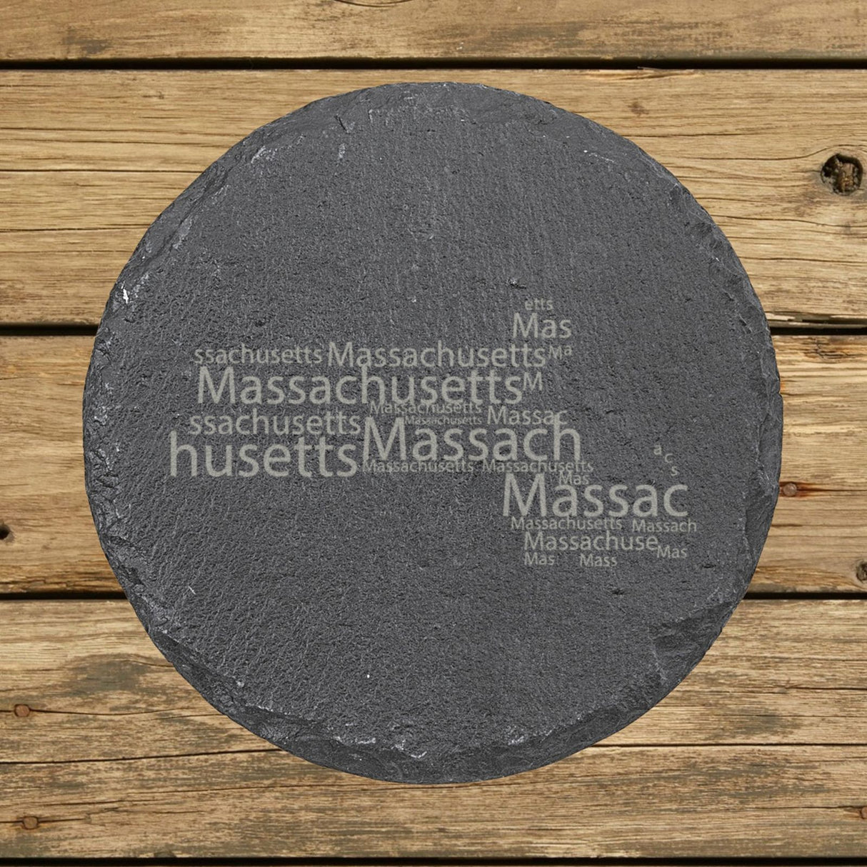 Massachusetts round slate coaster engraved with a word cloud of repeating Massachusetts text