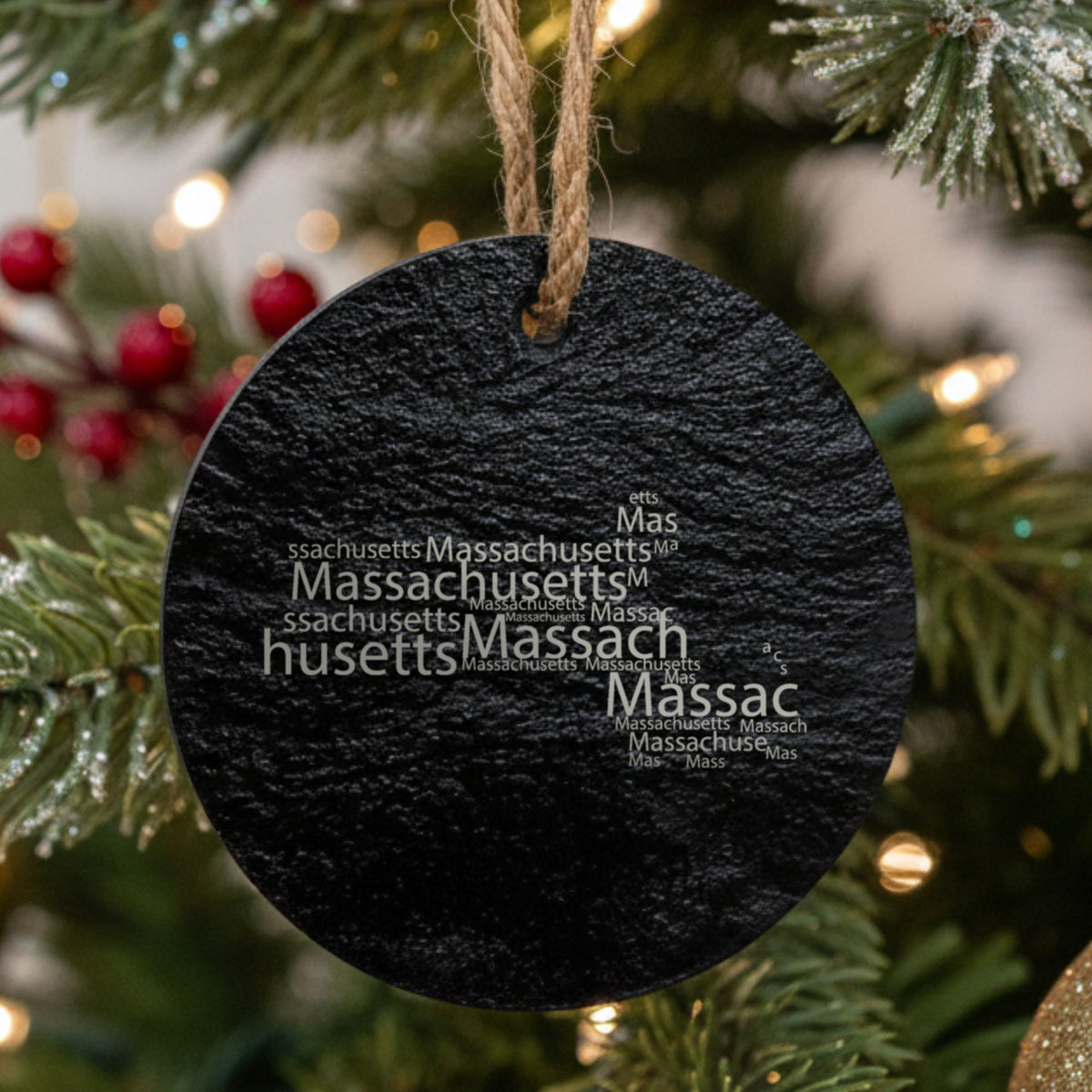 Massachusetts round slate Christmas ornament engraved with a word cloud of repeating Massachusetts text