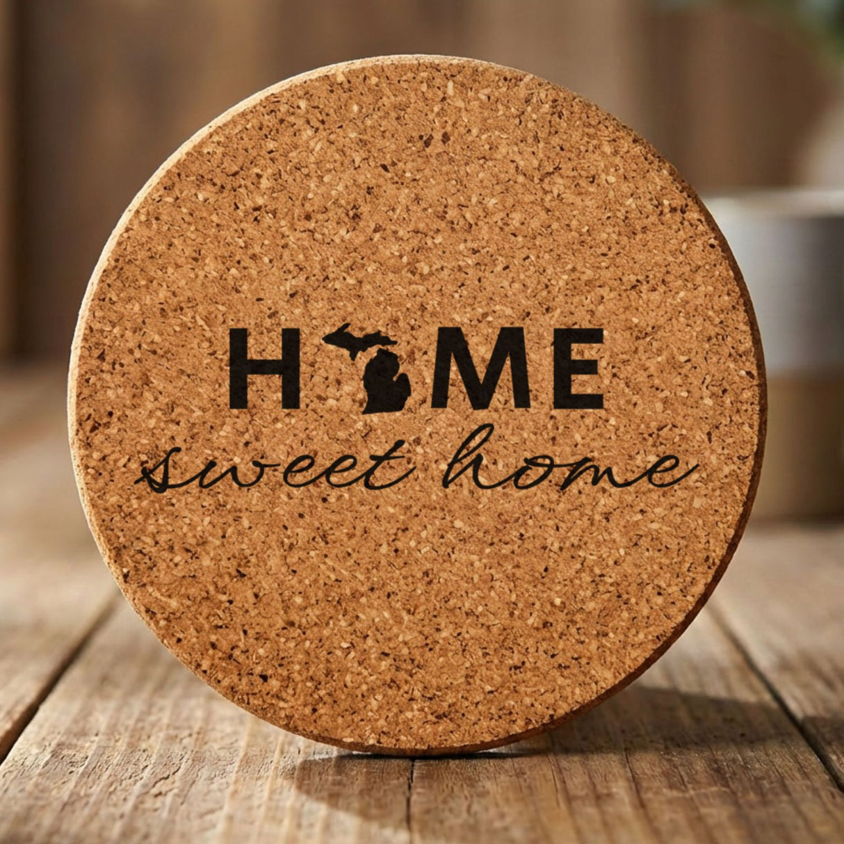 Michigan round cork coaster engraved with HOME sweet home using the state shape as the letter O