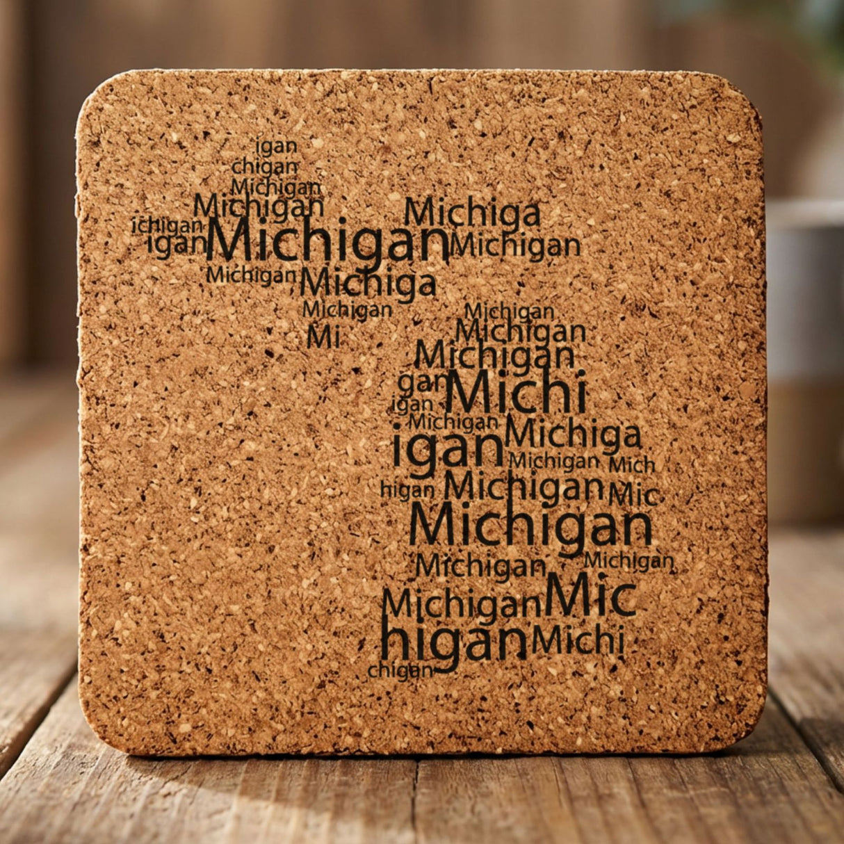 Michigan square cork coaster engraved with a word cloud of repeating Michigan text