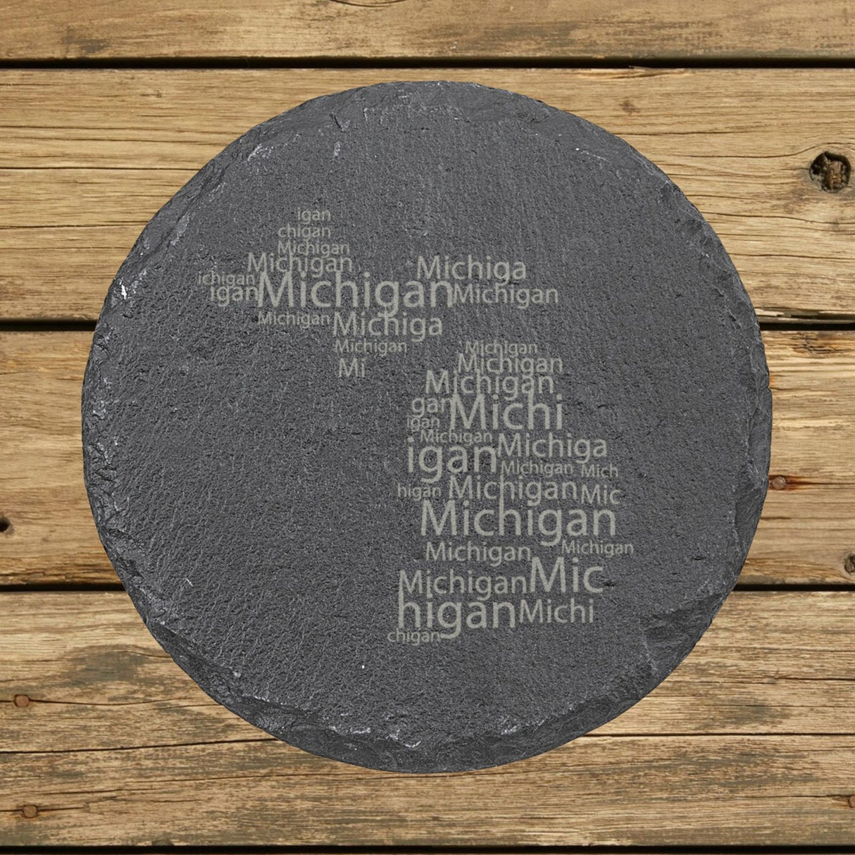 Michigan round slate coaster engraved with a word cloud of repeating Michigan text