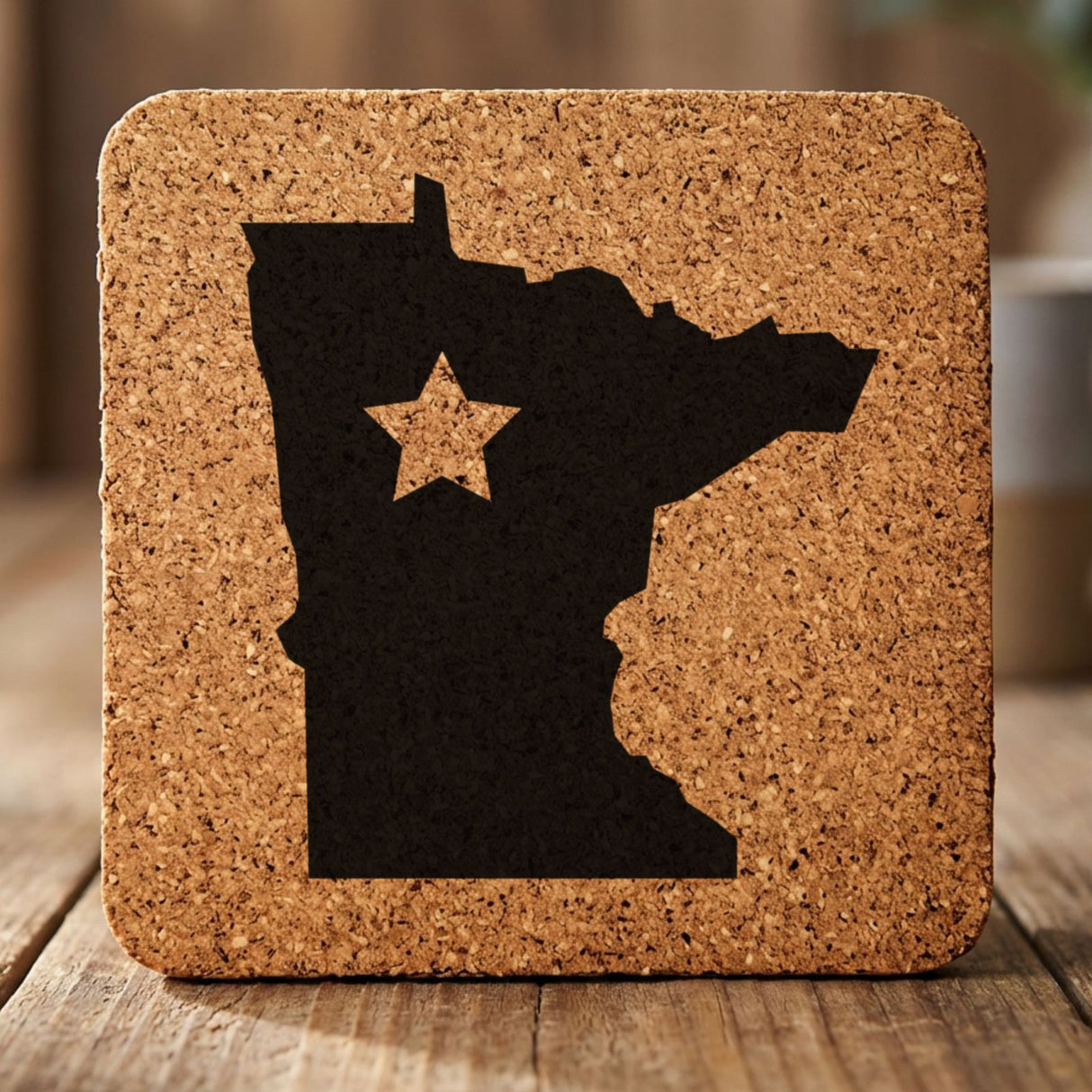 Minnesota square cork coaster engraved with the state shape and a star