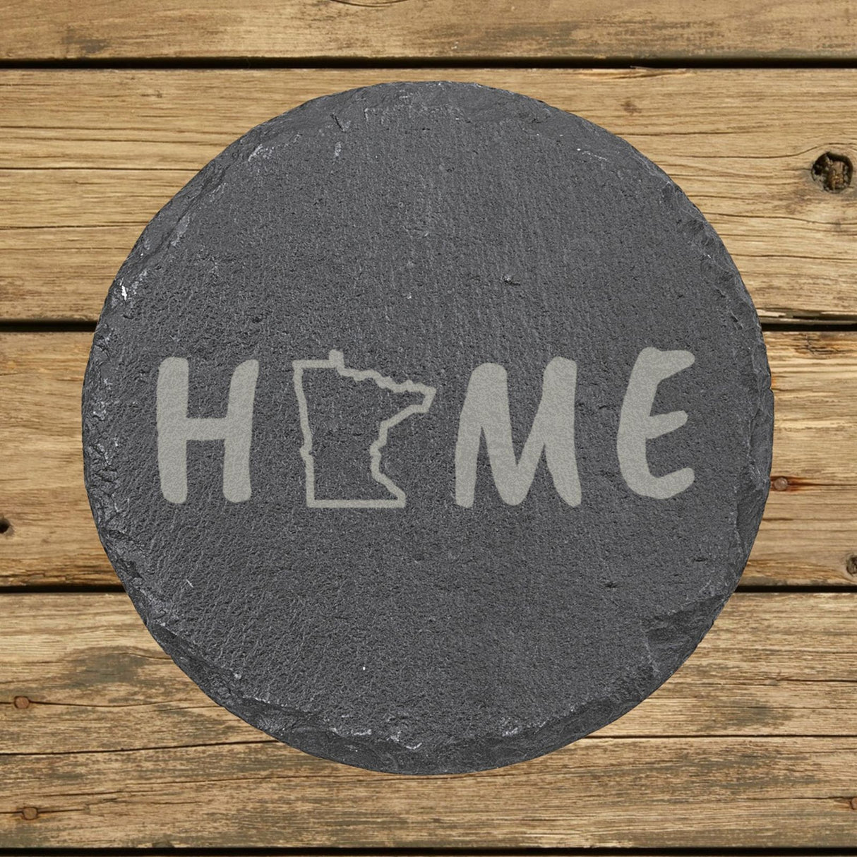 Minnesota round slate coaster engraved with HOME using the state outline as the letter O