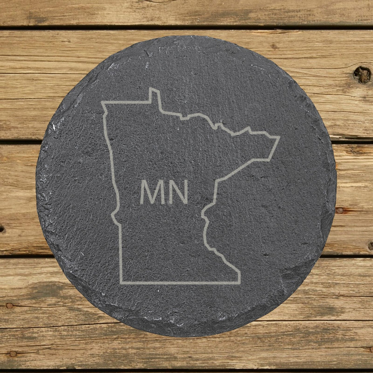 Minnesota round slate coaster engraved with the state outline and MN initials