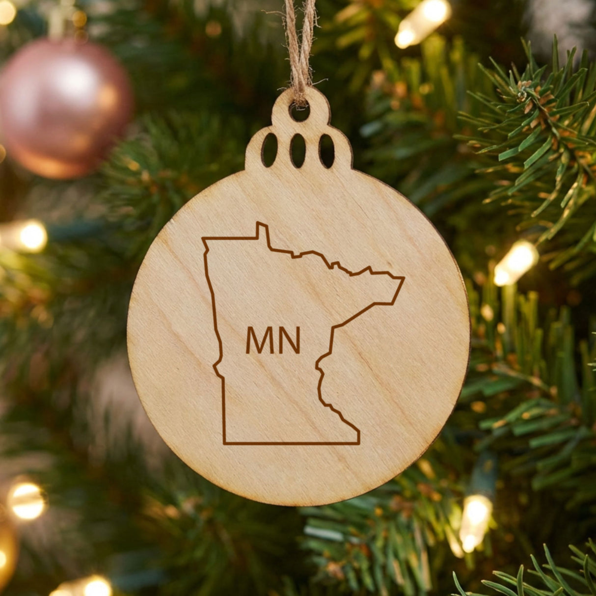 Minnesota round wood Christmas ornament engraved with the state outline and MN initials