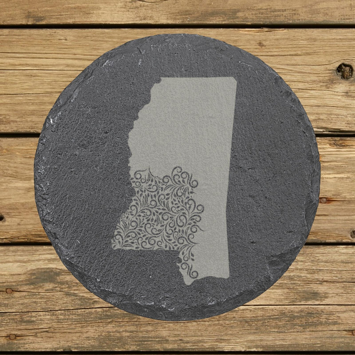 Mississippi round slate coaster engraved with the state shape in ornate floral scrollwork