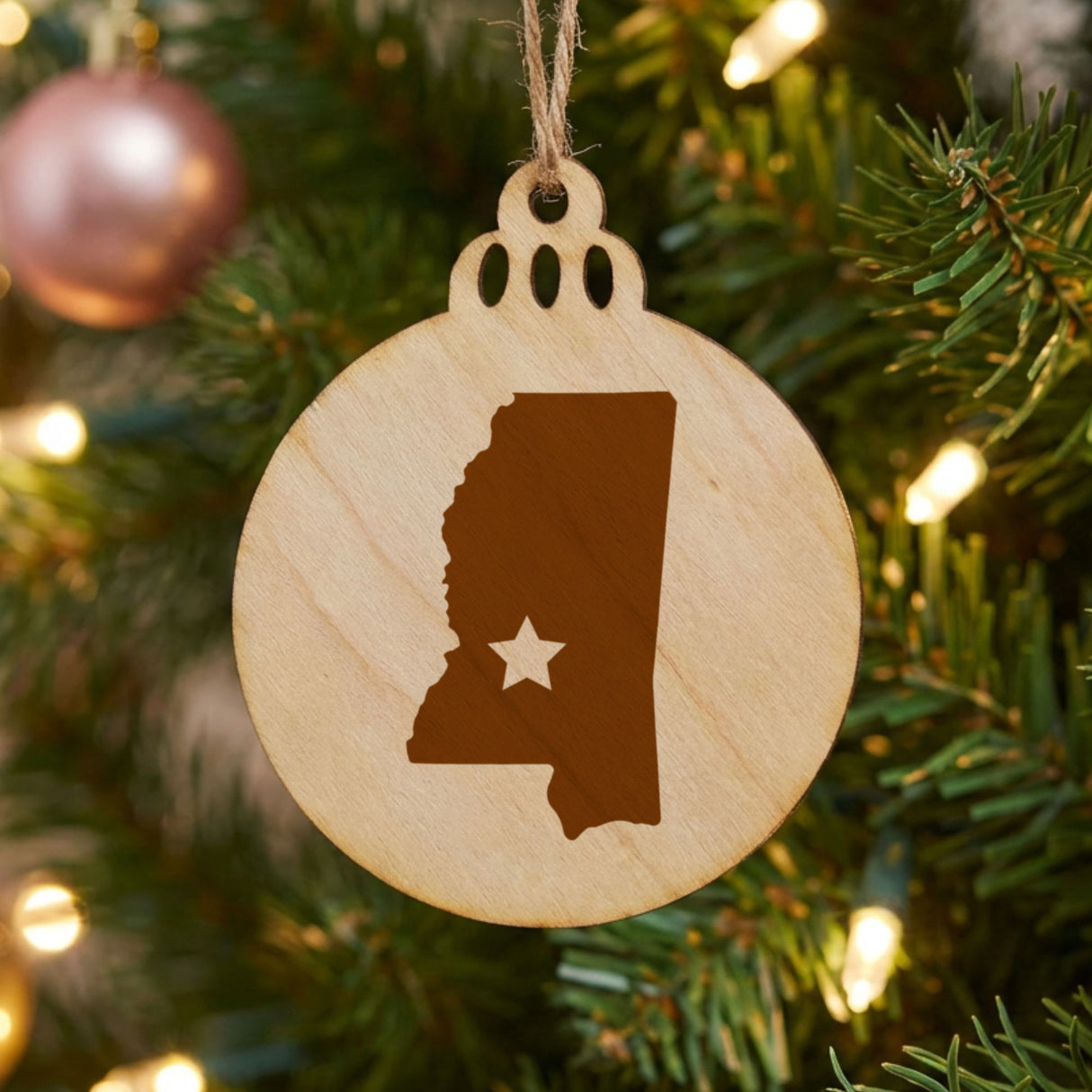 Mississippi round wood Christmas ornament engraved with the state shape and a star
