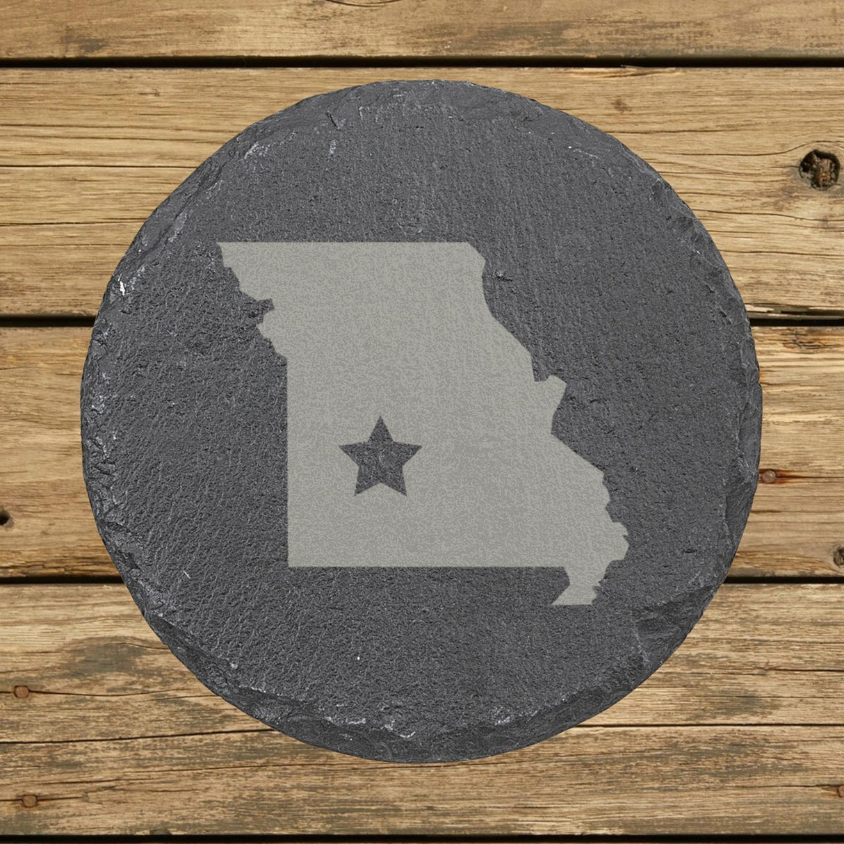 Missouri round slate coaster engraved with the state shape and a star