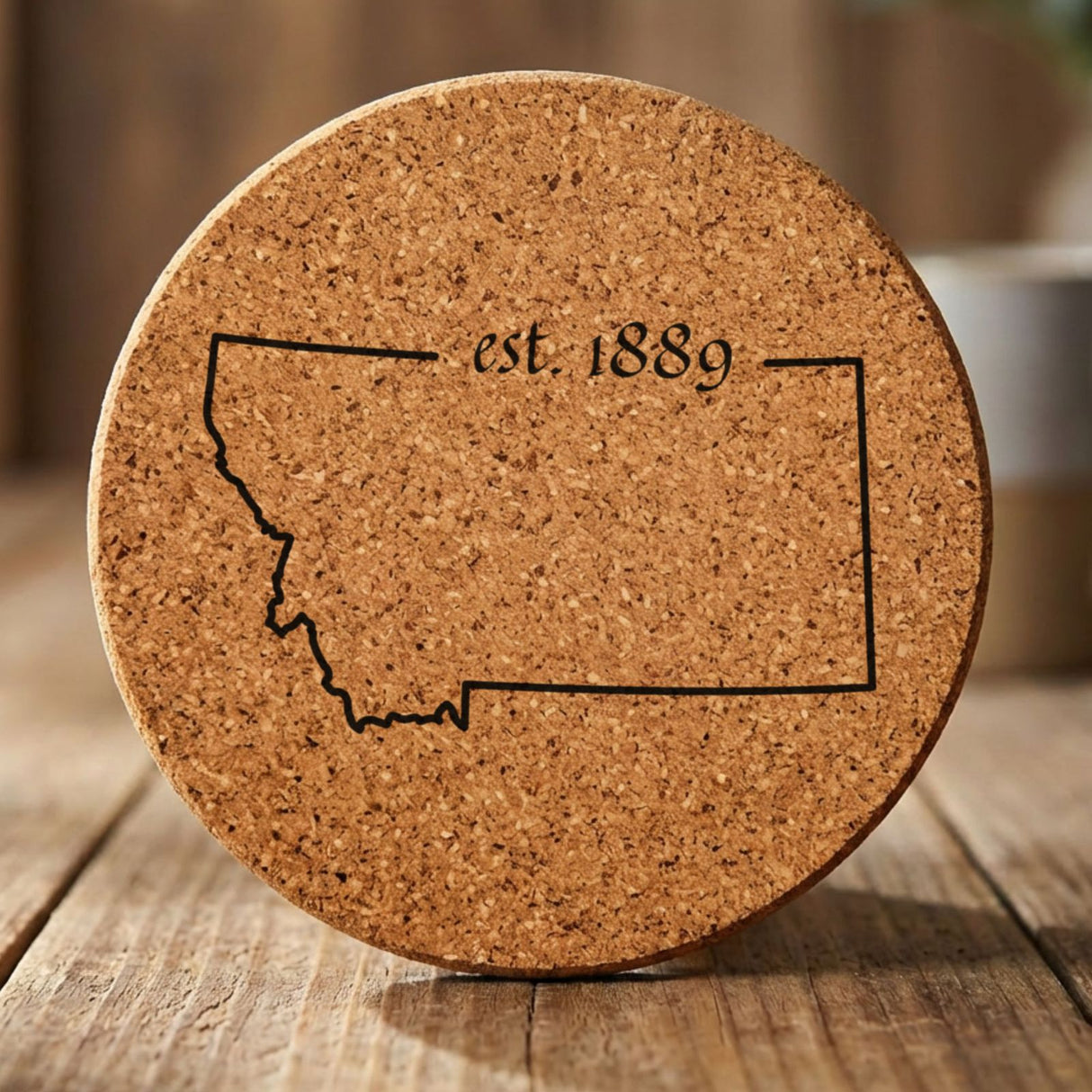 Montana round cork coaster engraved with the state outline and est. 1889