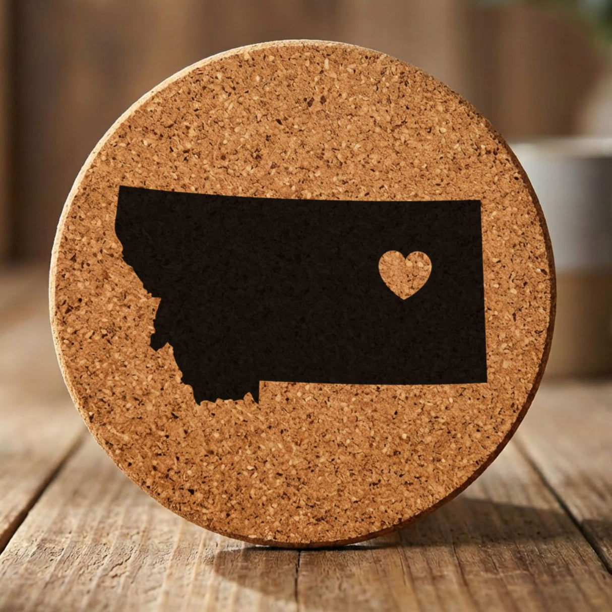 Montana round cork coaster engraved with the state shape and a heart