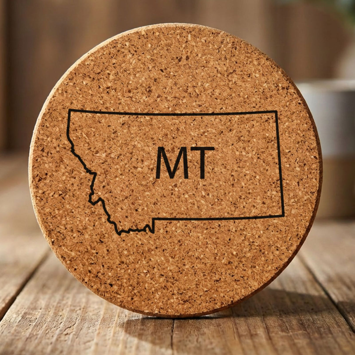 Montana round cork coaster engraved with the state outline and MT initials