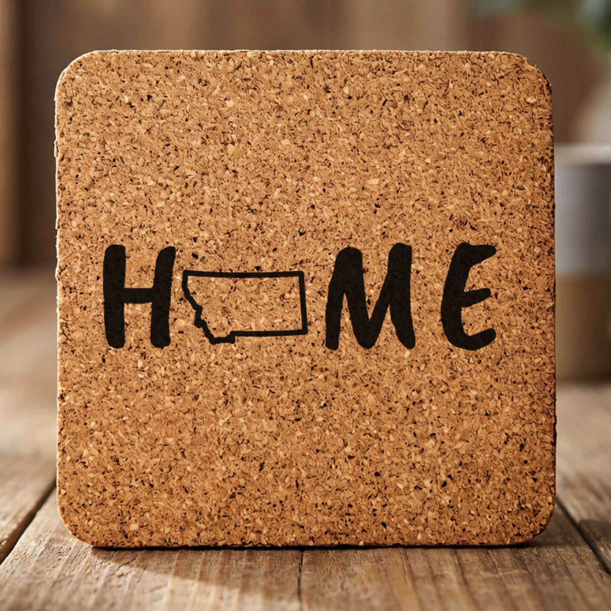 Montana square cork coaster engraved with HOME using the state outline as the letter O