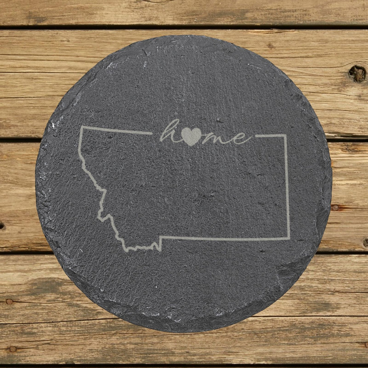 Montana round slate coaster engraved with the state outline and home in script with a heart