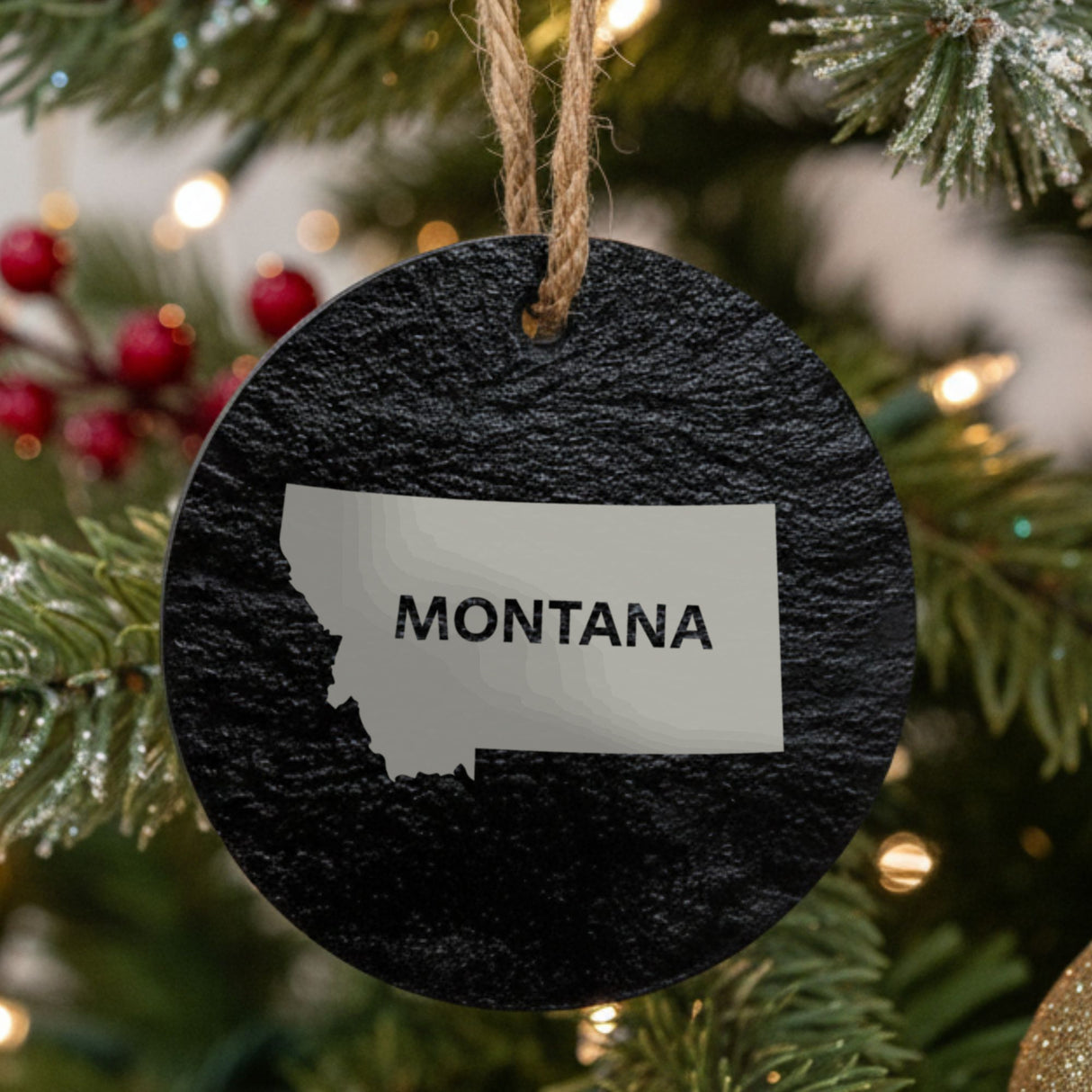Montana round slate Christmas ornament engraved with the state shape and MONTANA in bold lettering
