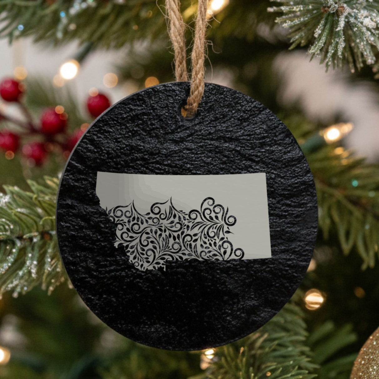Montana round slate Christmas ornament engraved with the state shape in ornate floral scrollwork