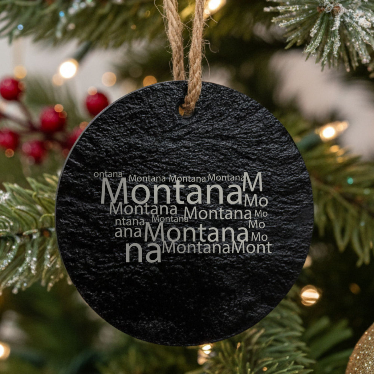 Montana round slate Christmas ornament engraved with a word cloud of repeating Montana text